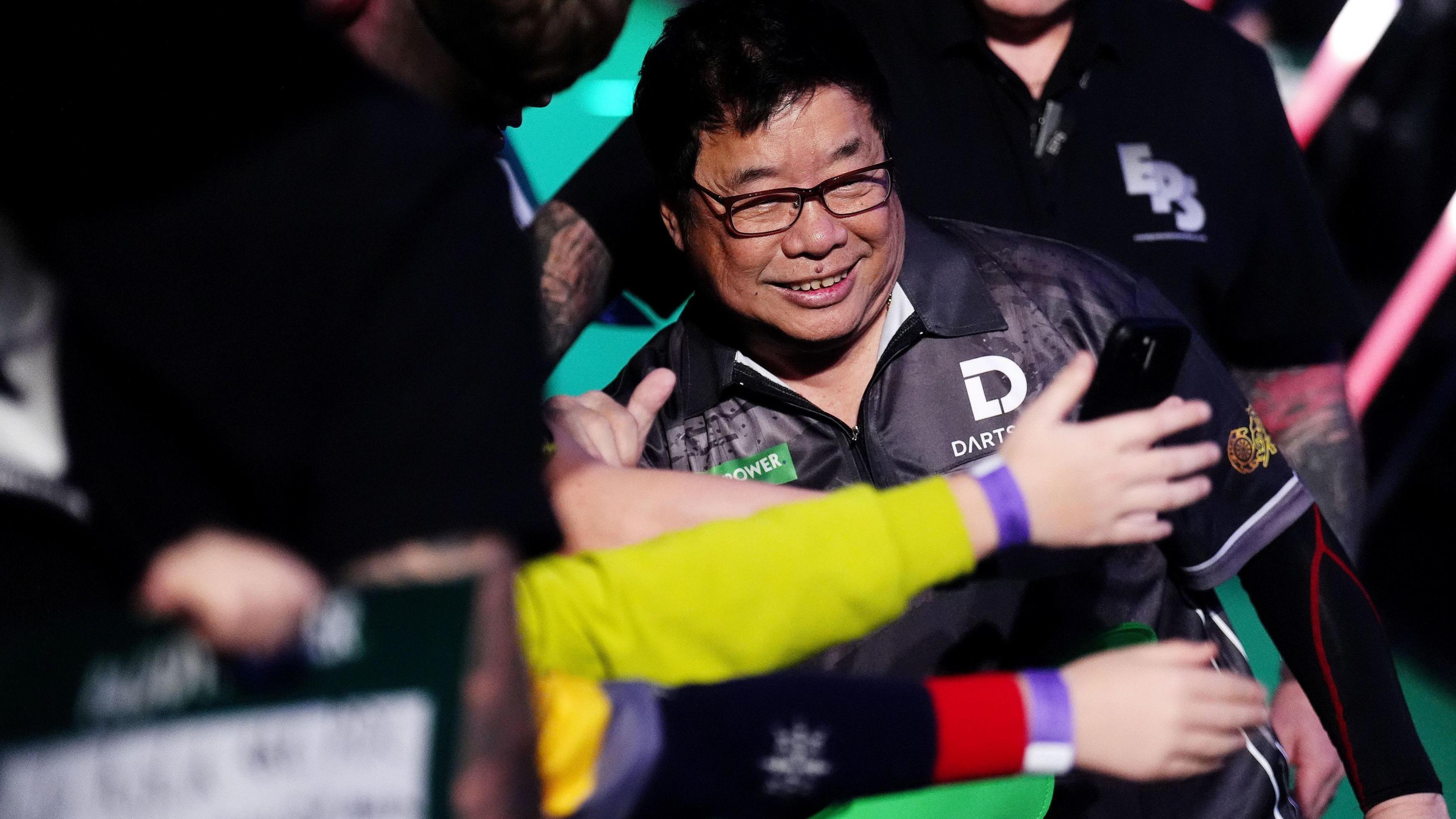 Paul Lim shakes hands with the crowd at Alexandra Palace