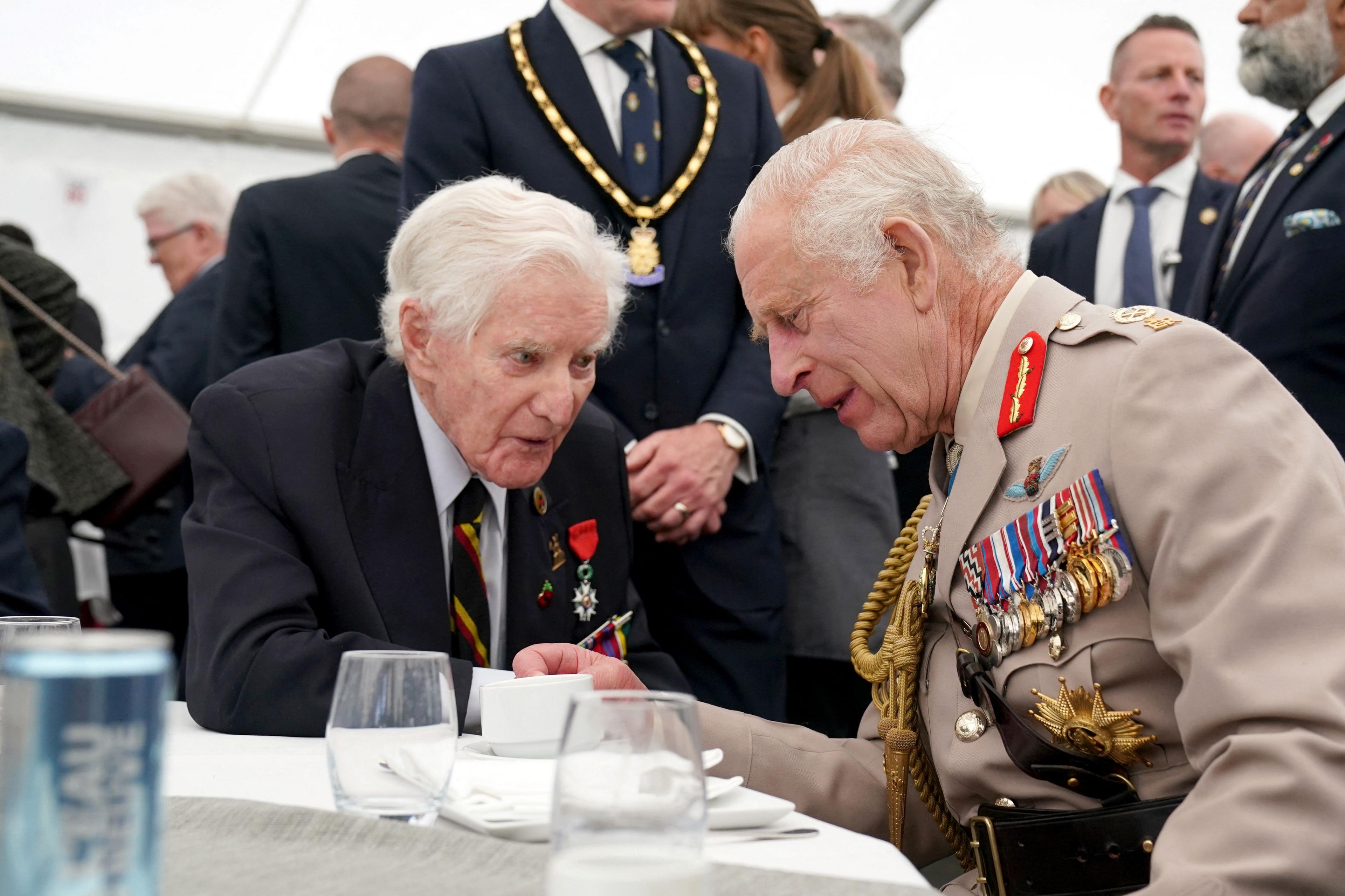 Britain's King Charles speaks to a D-Day veteran during a lunch following the UK national commemorative event for the 80th anniversary of D-Day, held at the British Normandy Memorial in Ver-sur-Mer, Normandy, France, June 6, 2024.