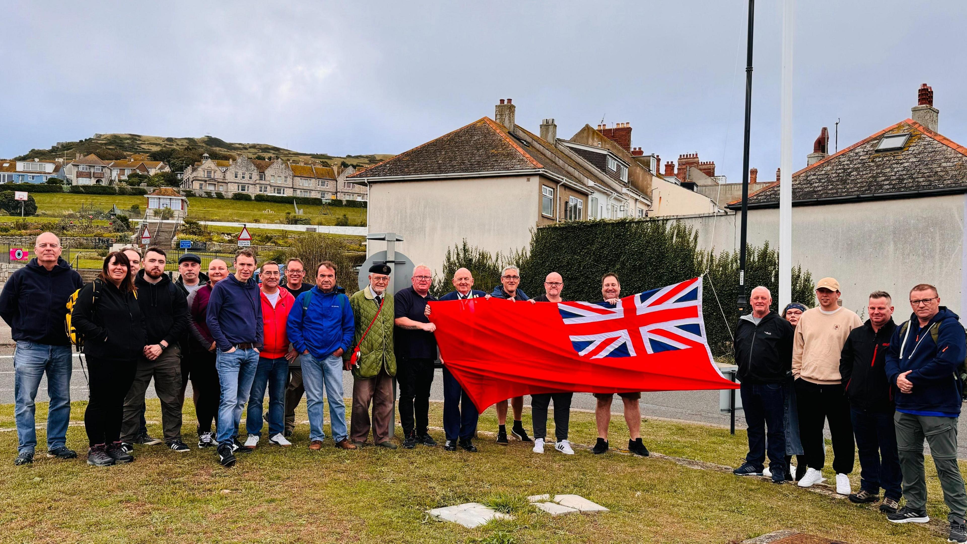 RMT National Secretary Darren Procter joins seafarers at Portland and they are hoisting the Red Ensign flag.