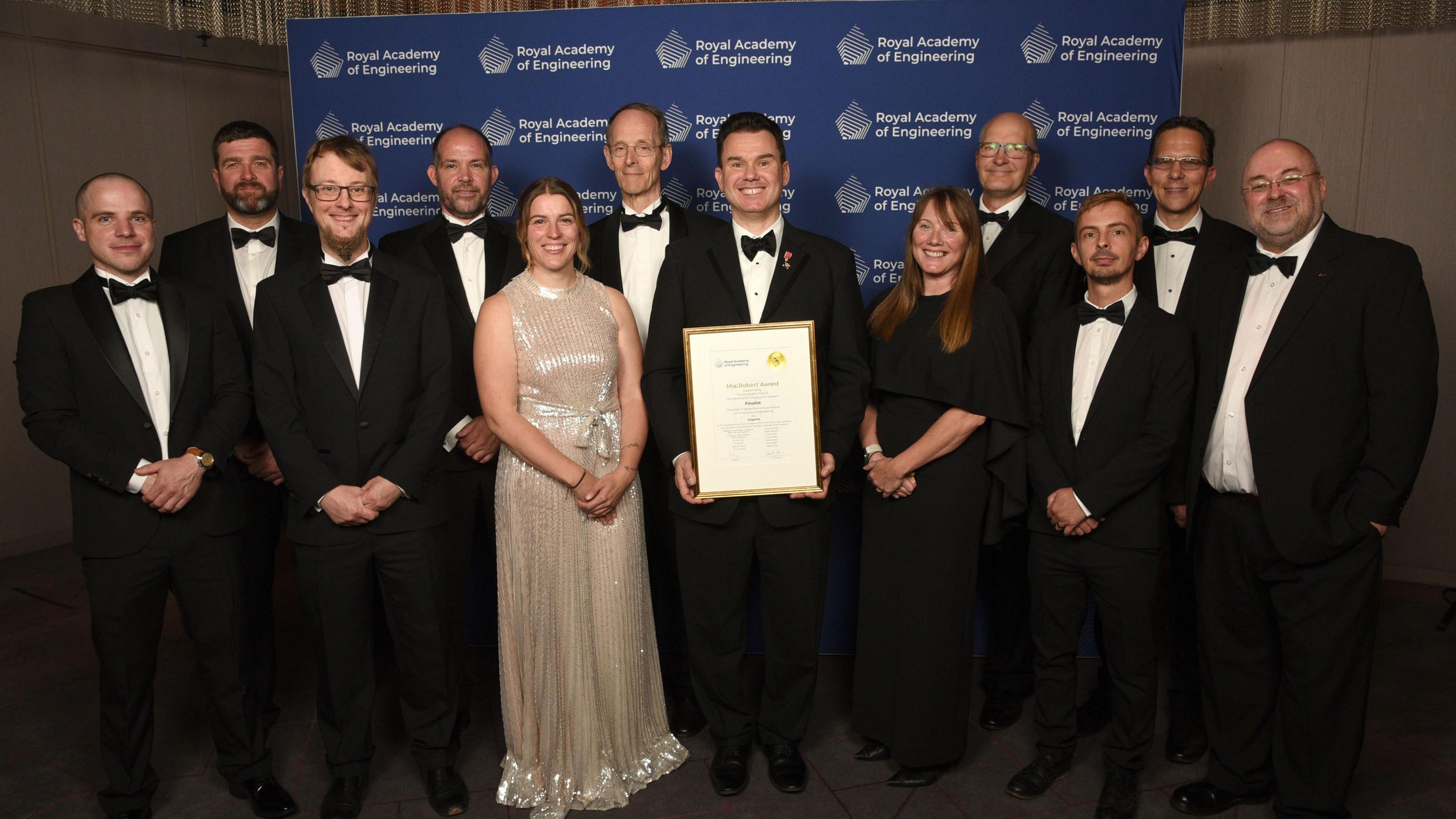 The OrganOx team at the Royal Academy of Engineering award ceremony, with Prof Constantin Coussios in the middle, holding the award. The team is smiling for the camera.