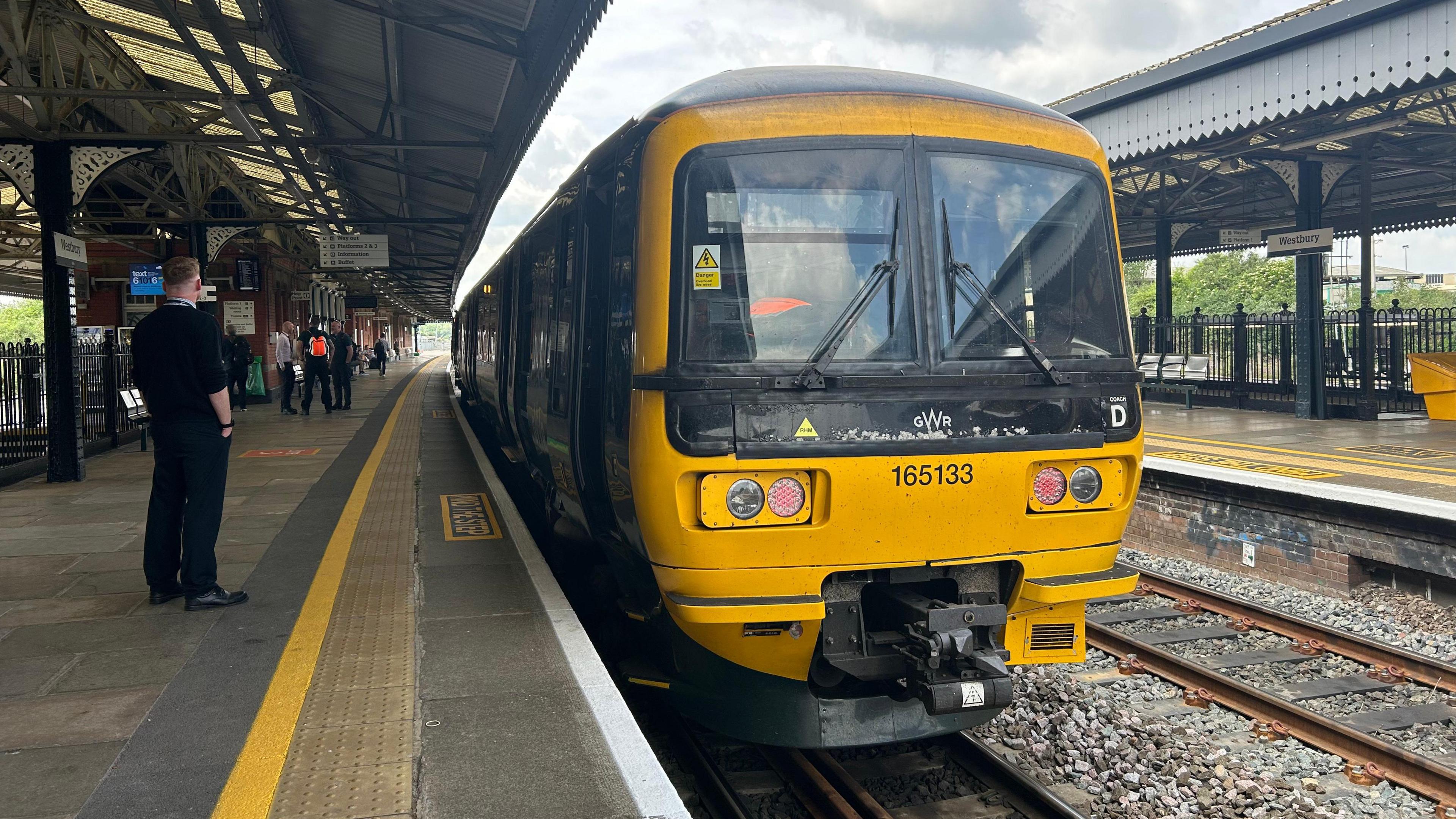 A local train service waiting at a platform at Westbury, Wiltshire