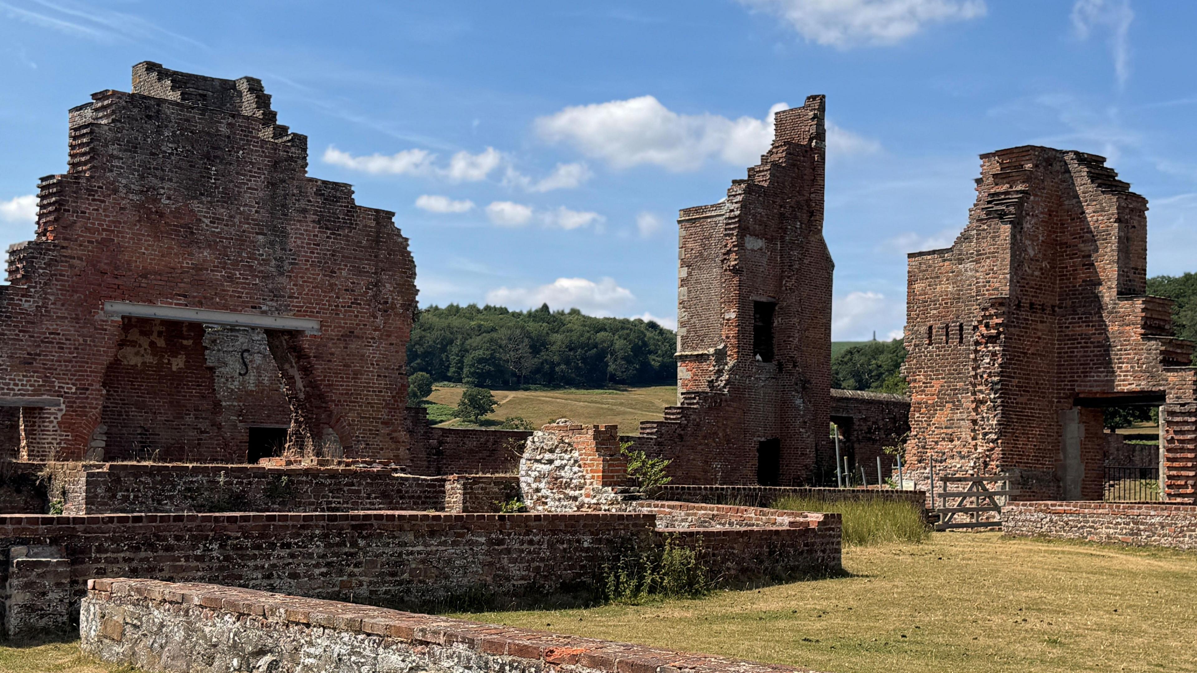 Ruins at Bradgate Park, with trees and blue sky in the background