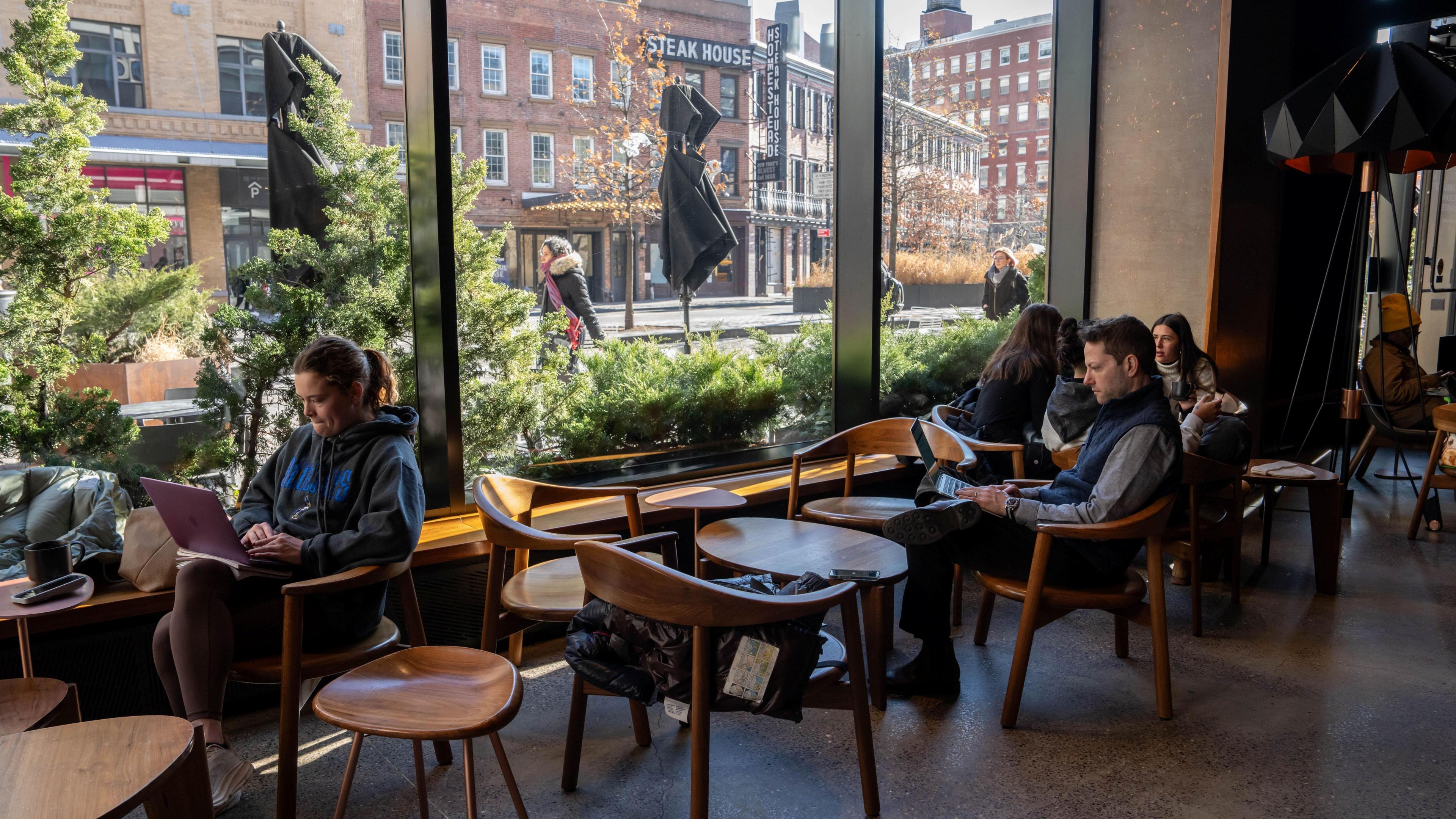 People use laptops inside of a Starbucks on January 14, 2025 in New York City.
