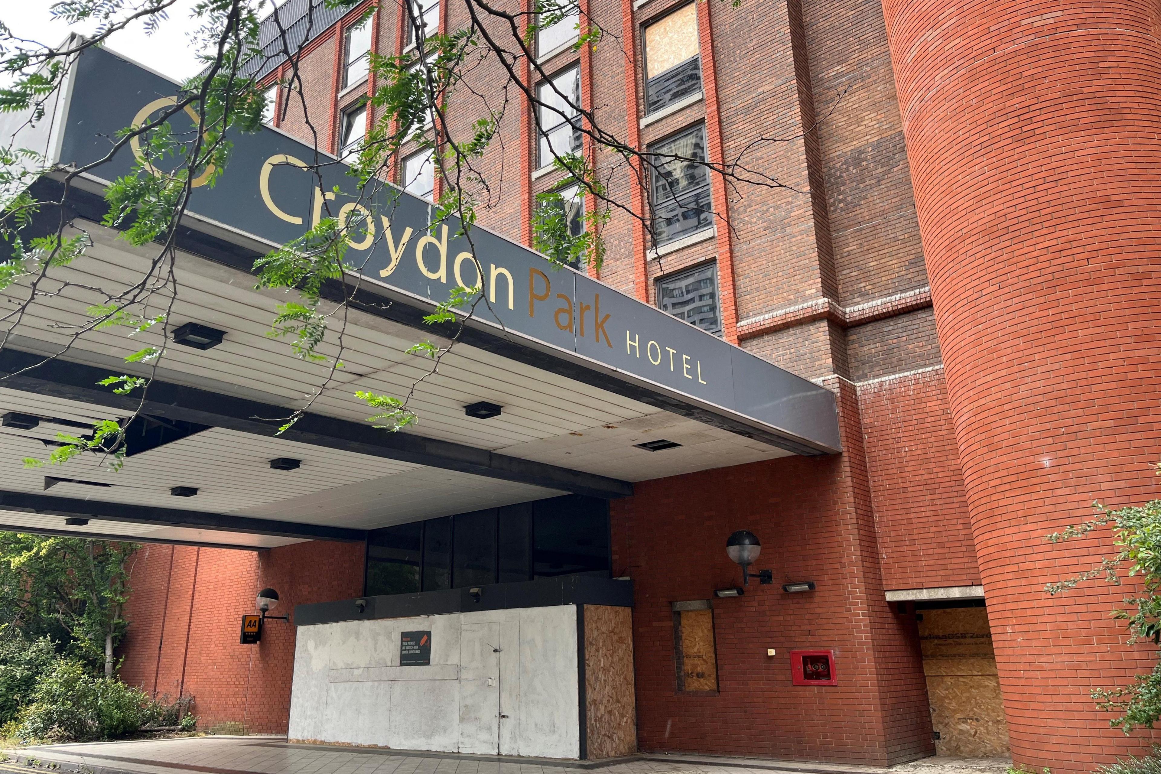 Front entrance of former Croydon Park hotel which is no longer in use. Its entrance and some windows are boarded up.