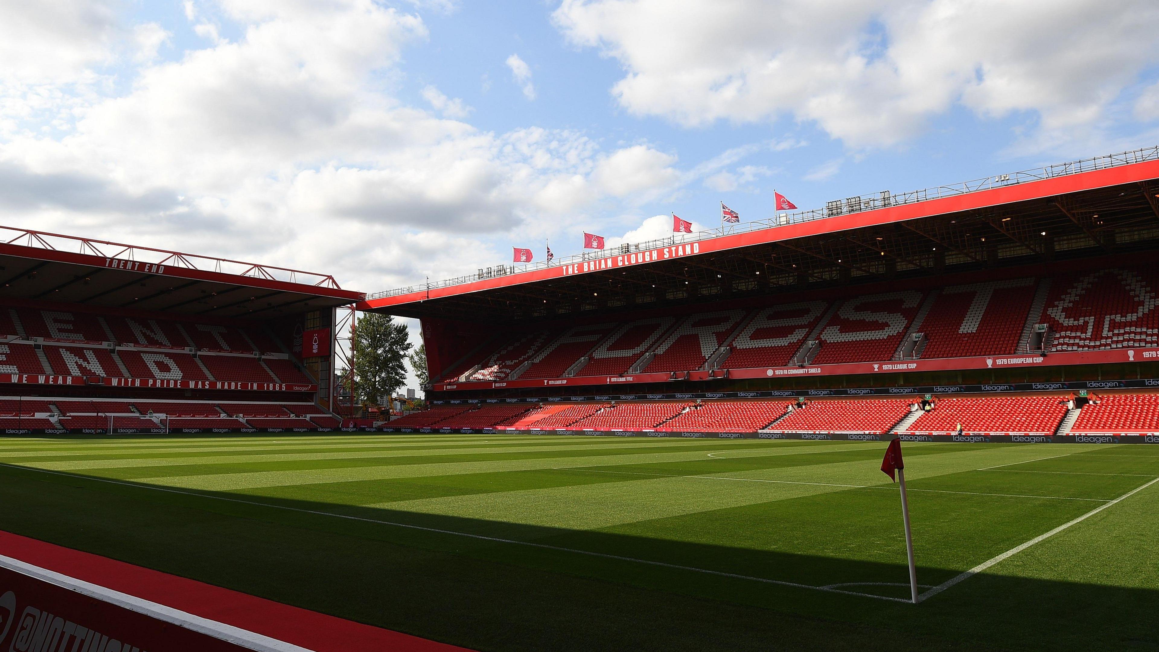 An empty shot of the City Ground from the corner flag, showing the Trent End on the left and the Brian Clough Stand in the centre with red seats