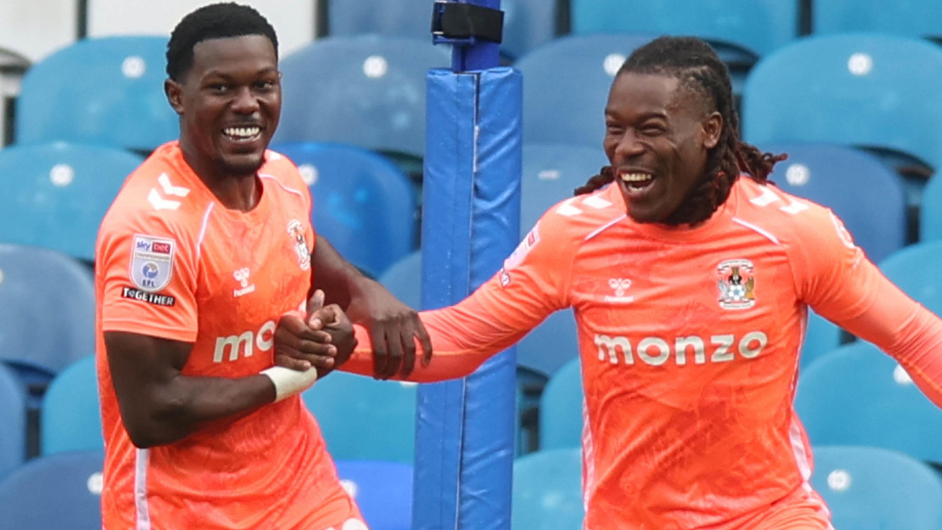 Ephron Mason-Clark (left) and Brandon Thomas-Asante (right), both wearing Coventry City's bright orange away strip, give each other five while celebrating a goal at Sheffield Wednesday in October 