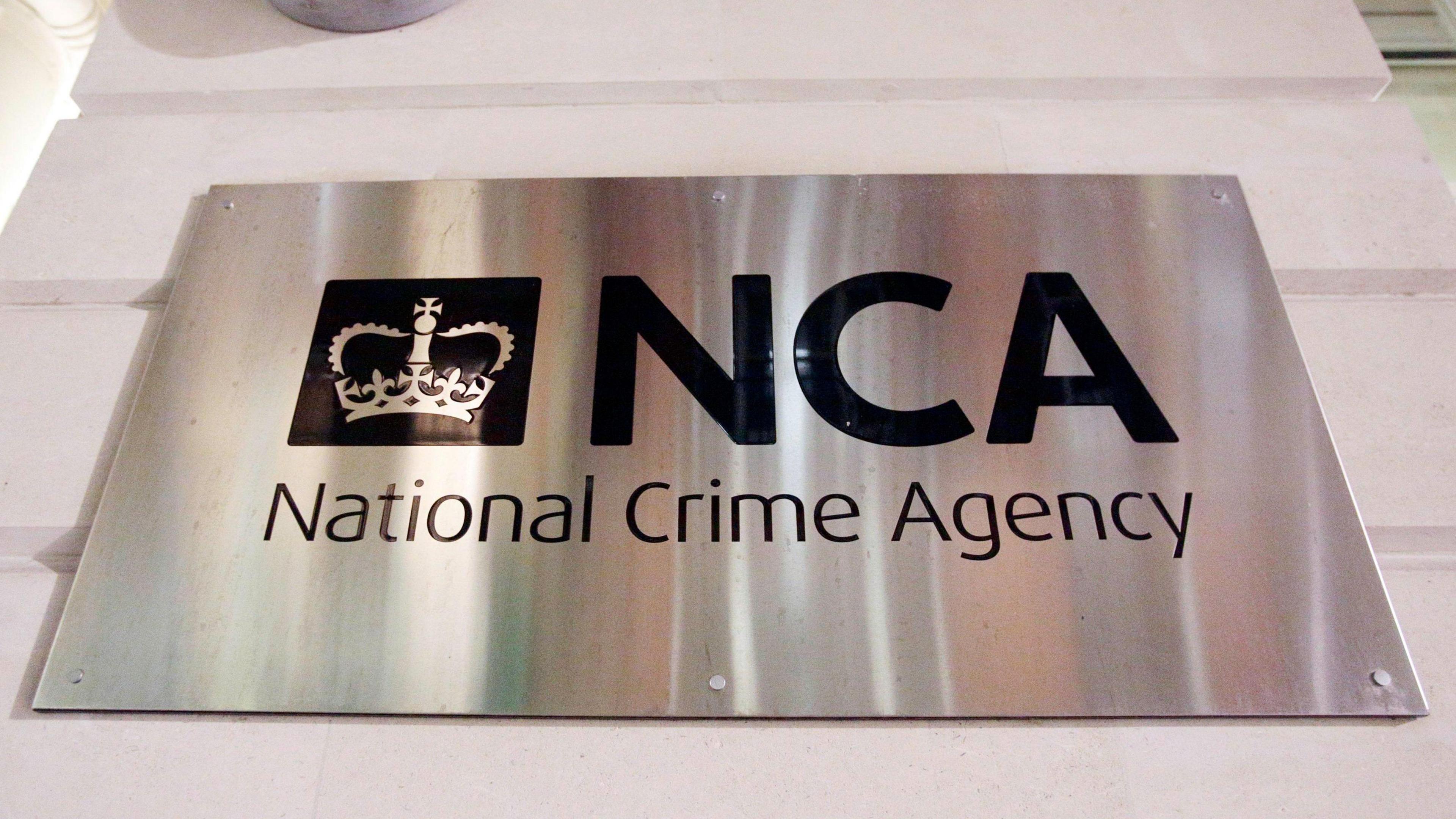 Photograph of a metallic sign outside the National Crime Agency headquarters in central London. 