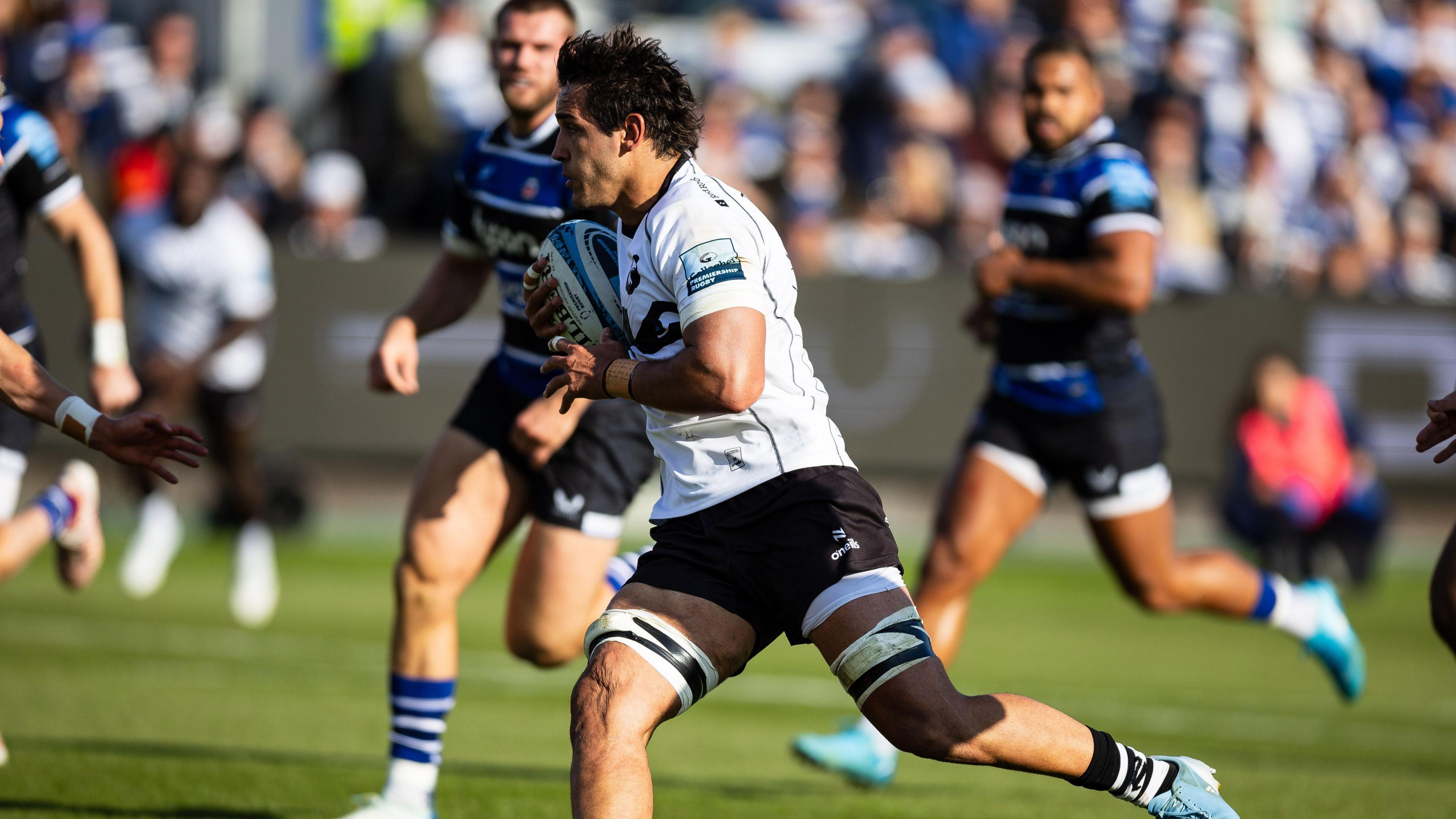 Santiago Grondona runs with the ball before scoring a try