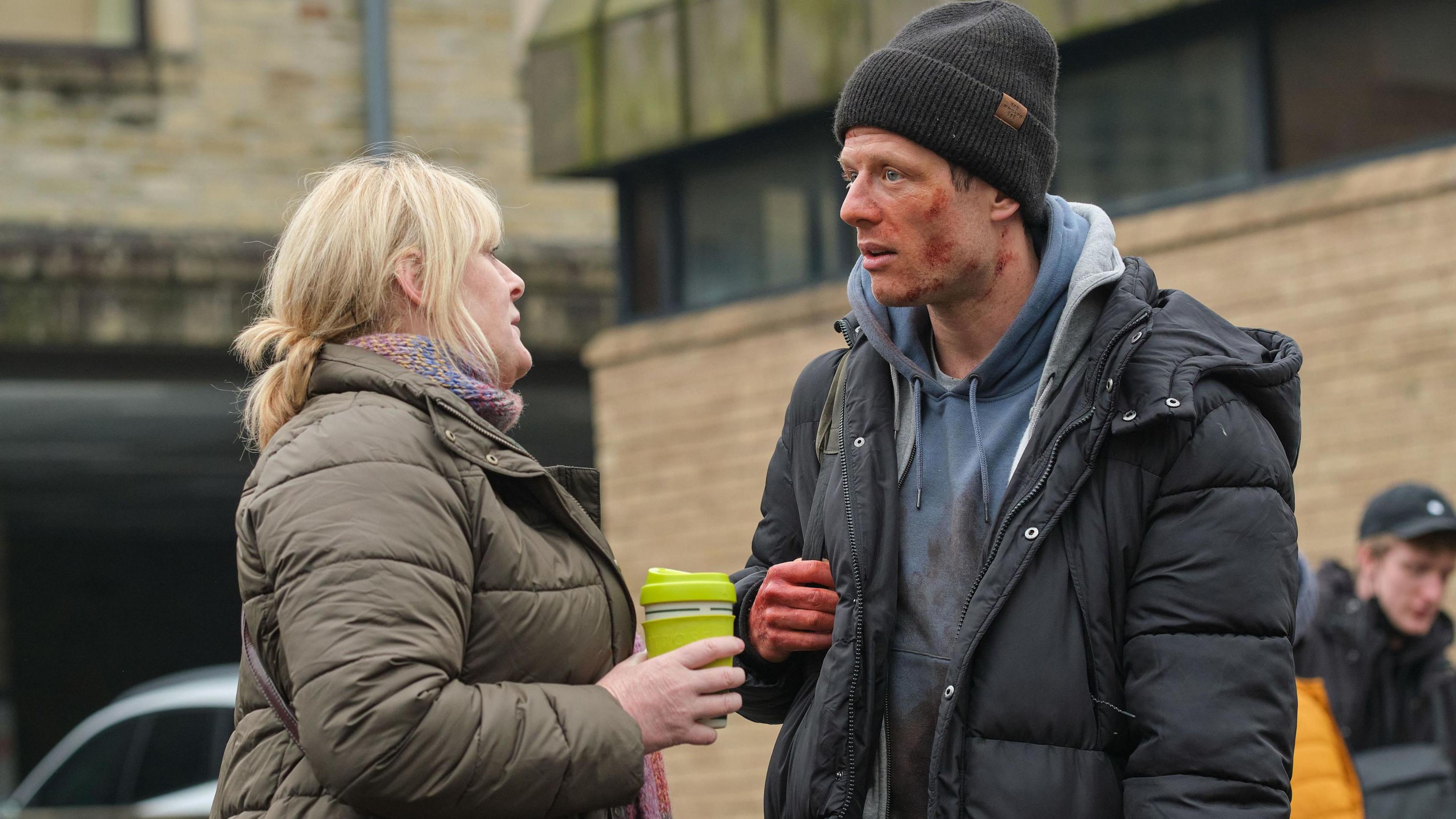 The actress Sarah Lancashire on the left talking to a blood-stained James Norton on the right on the set of Happy Valley.