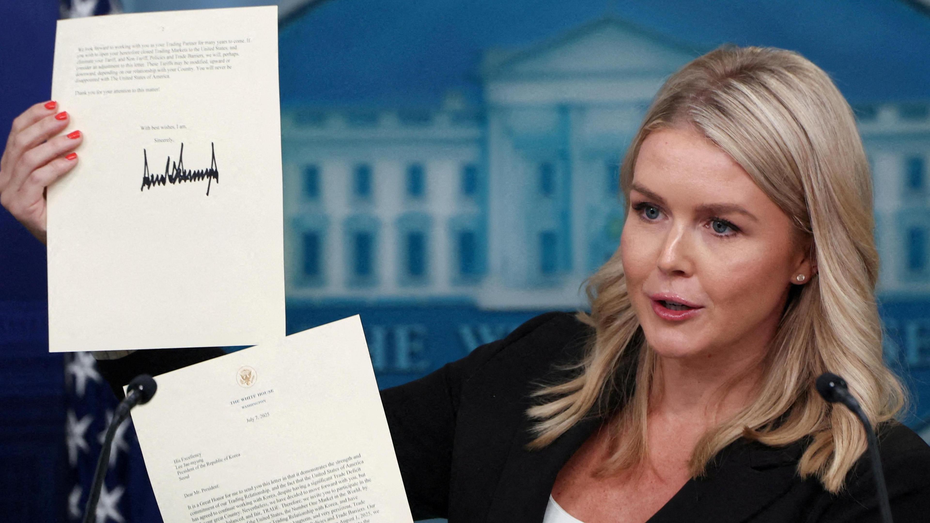 White House Press Secretary Karoline Leavitt shows a signed letter on tariffs from US President Donald Trump