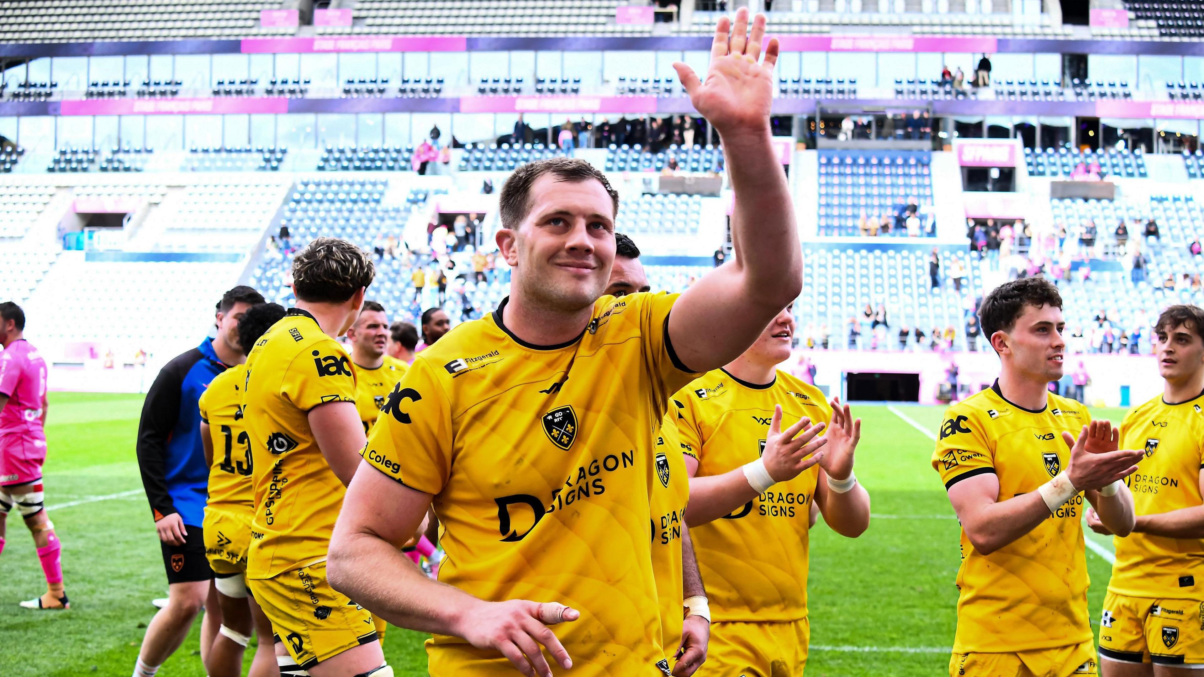Dragons co-captain Ben Carter waves to the crowd after helping his side beat Stade Francais