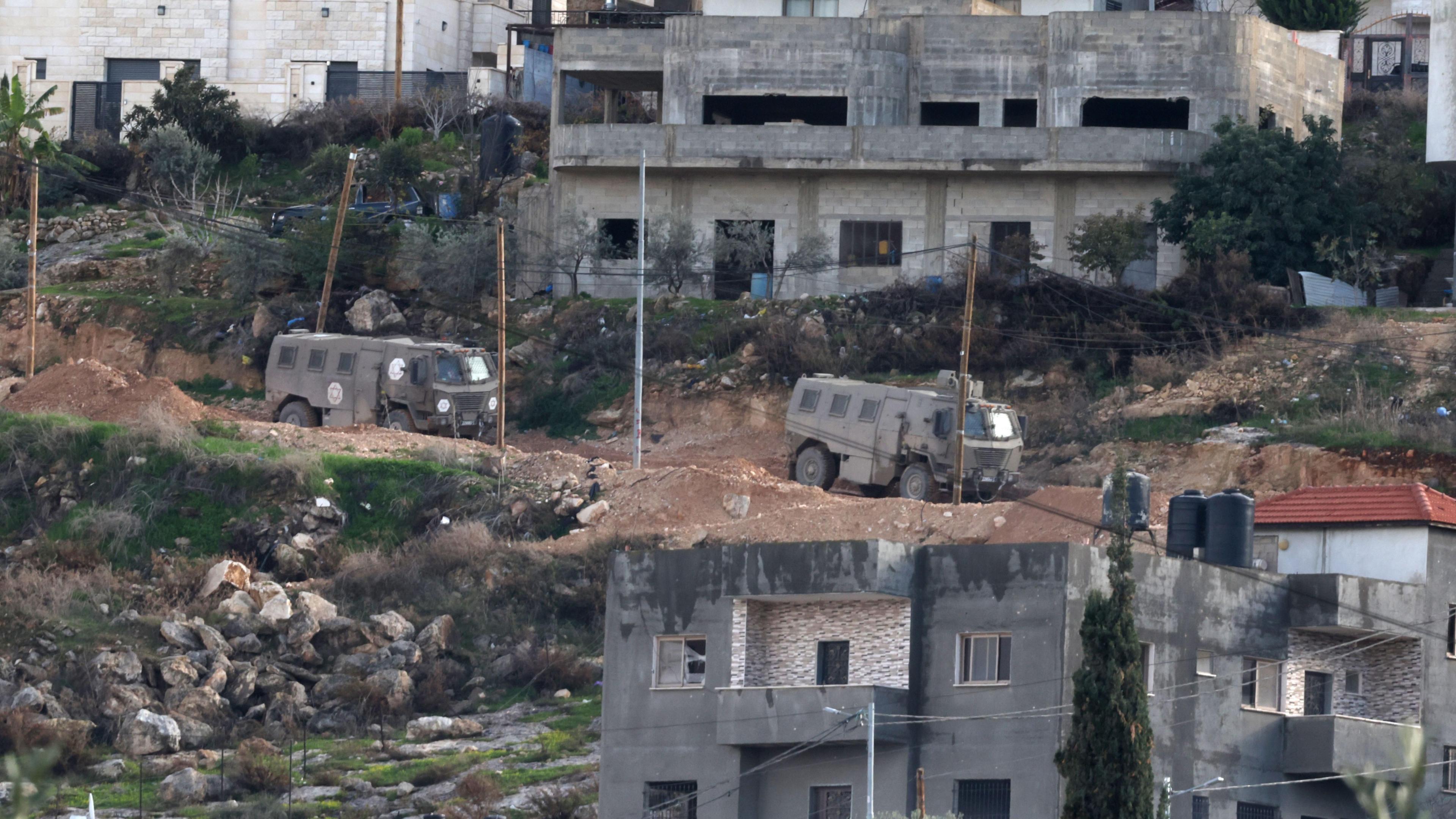 Israeli military vehicles manoeuvre in Jenin refugee camp, in the occupied West Bank (23 January 2025)