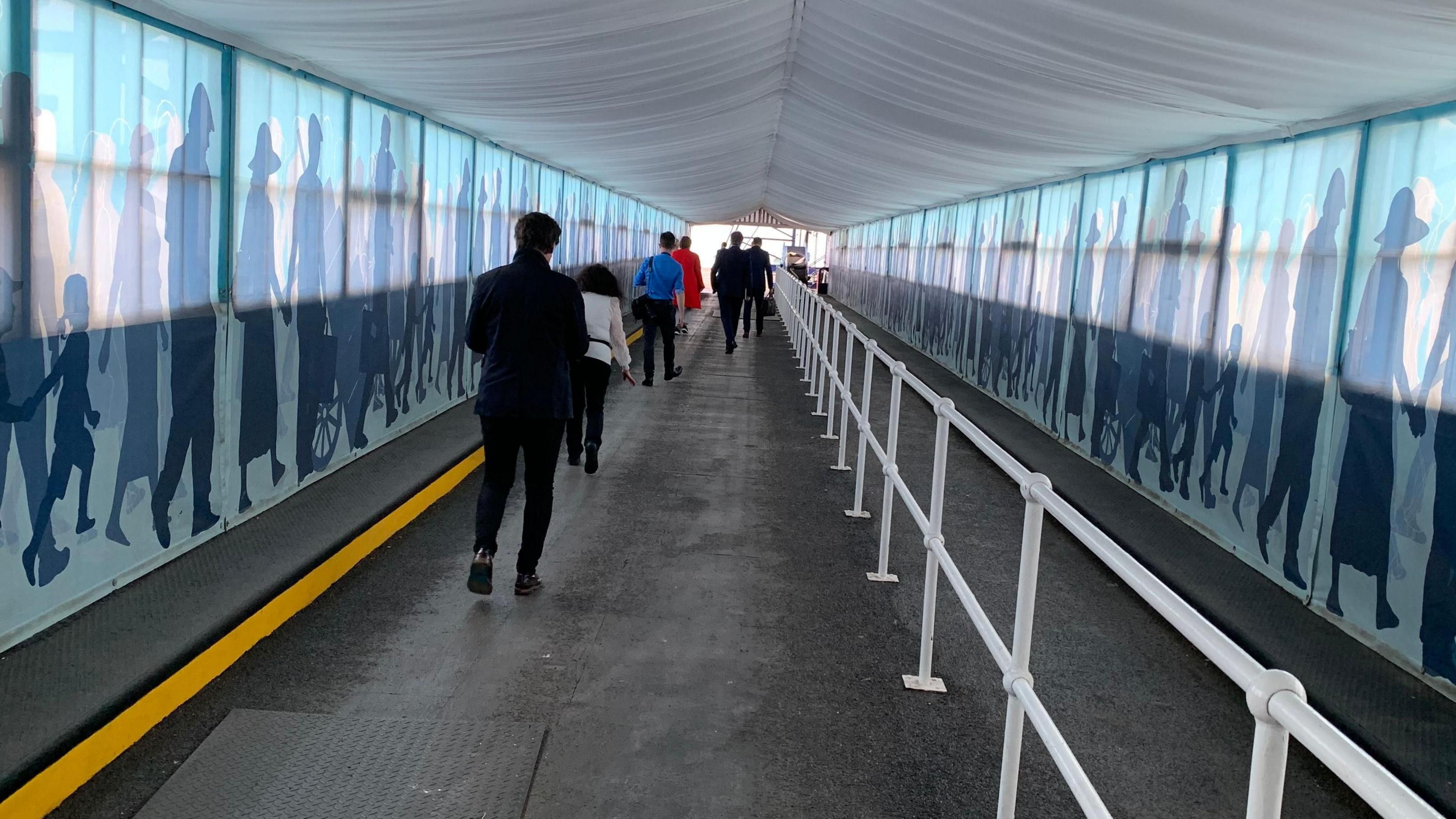 Passengers walking to board the ferry