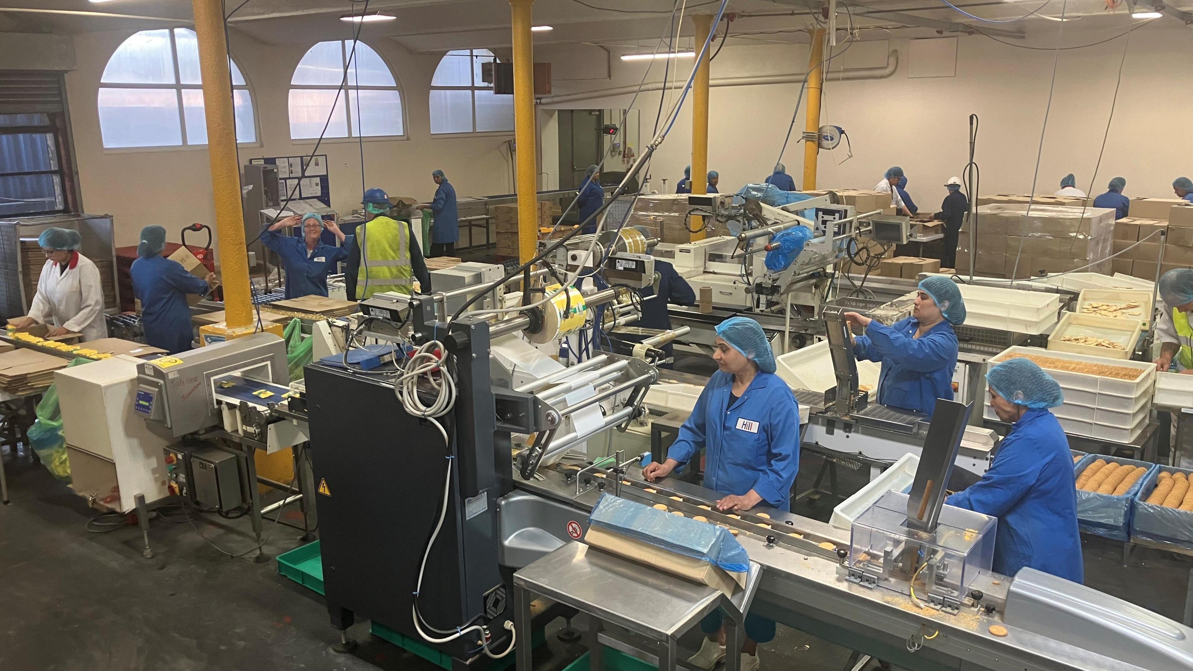 Workers packaging the biscuits at the Hill bakery in Ashton-under-Lyne. Dozens of people are working on the production lines.