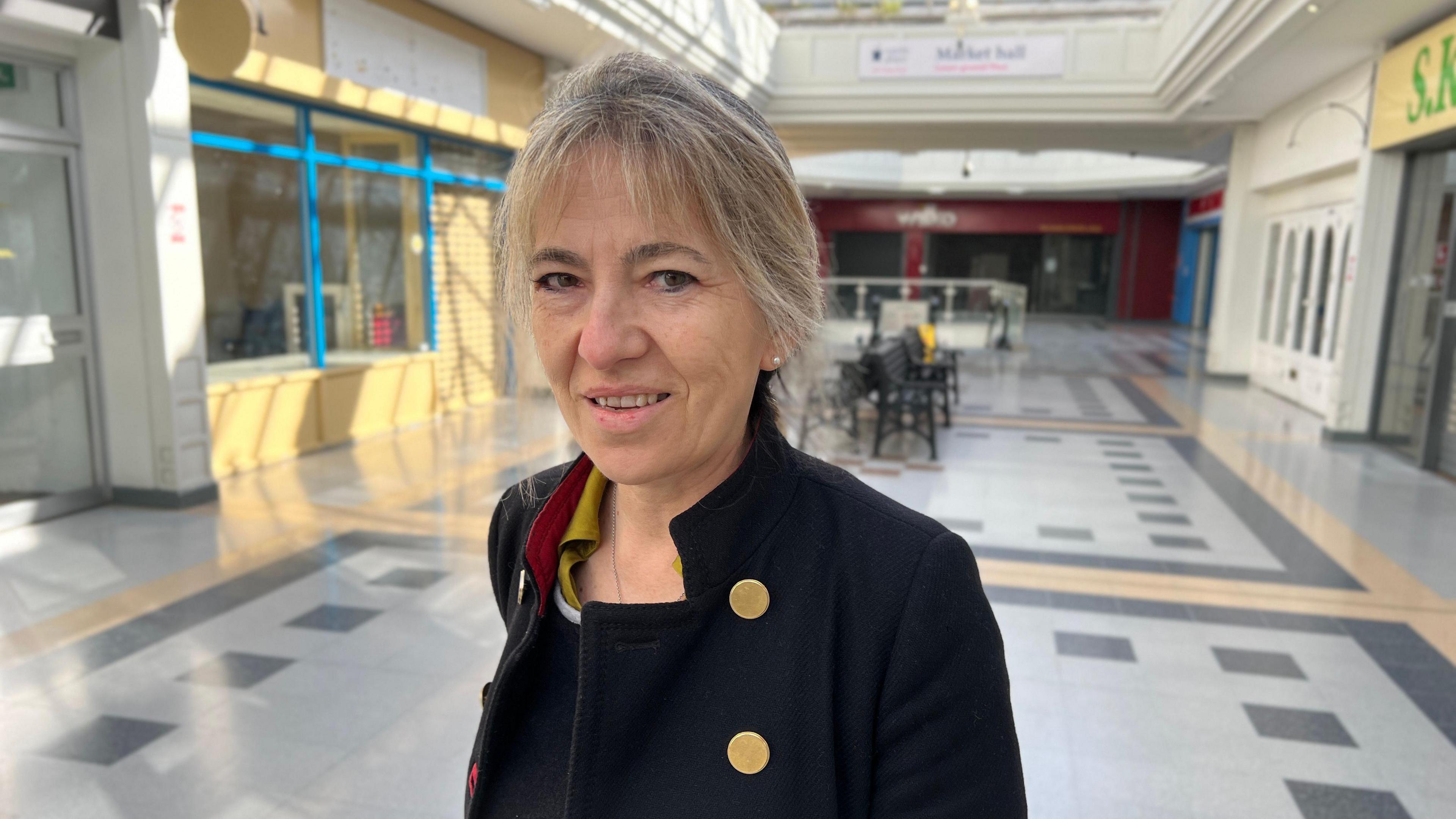 Kez Garner in front of empty shops in the main mall