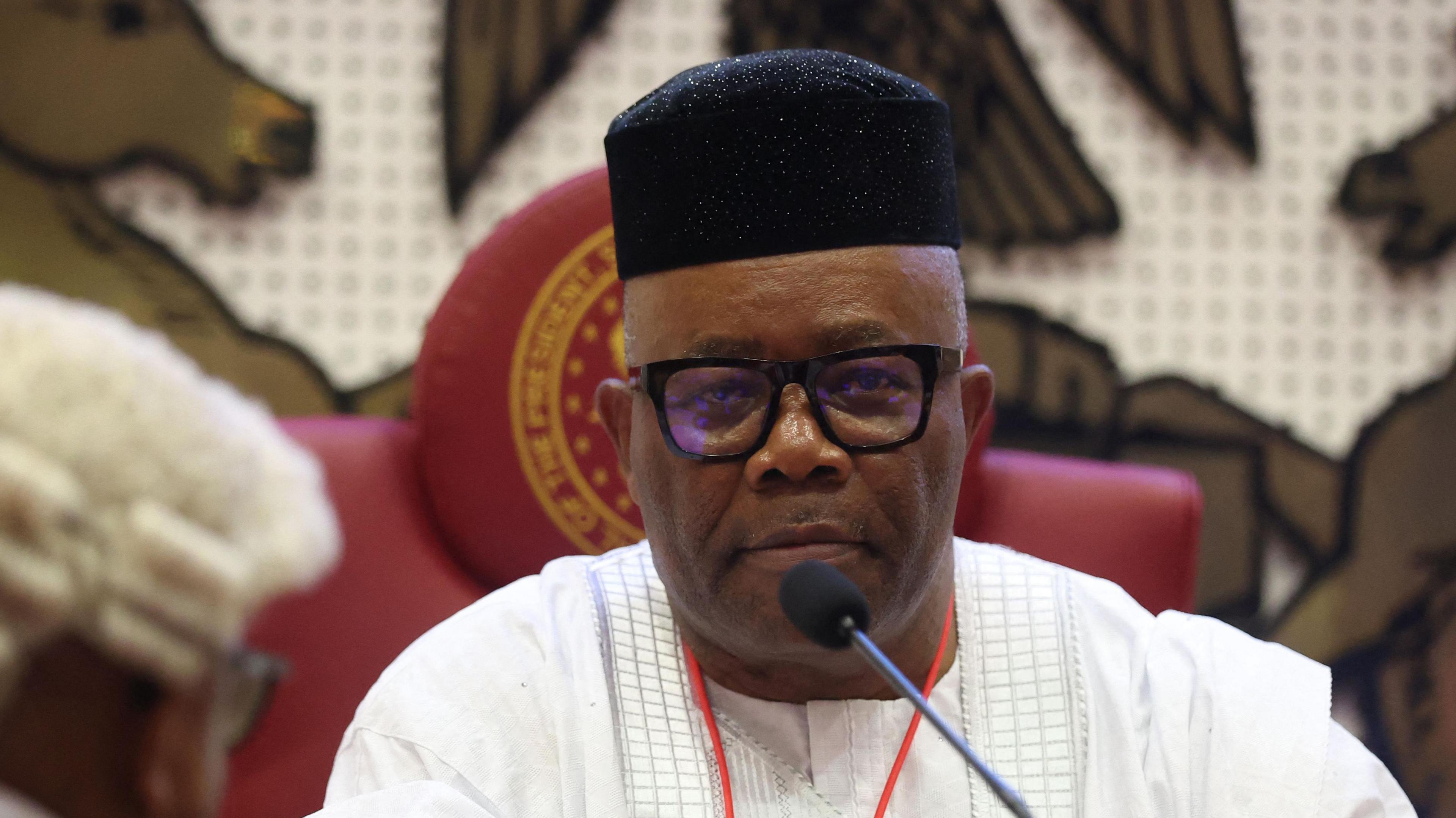 Nigeria’s senate president Godswill Akpabio wearing a black cap and white gown