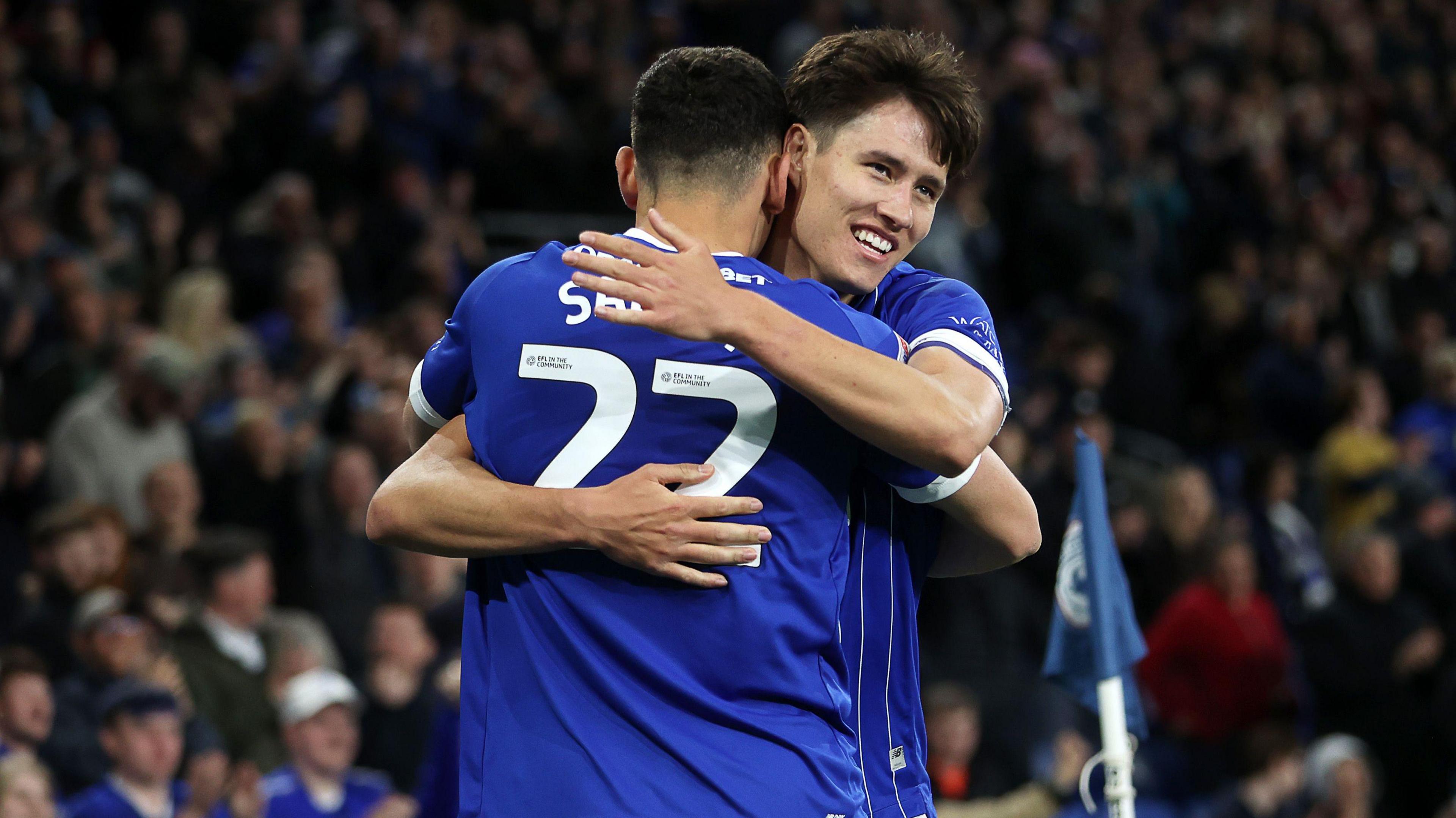 Rubin Colwill is hugged by Cardiff team-mate Yousef Salech after scoring against Port Vale