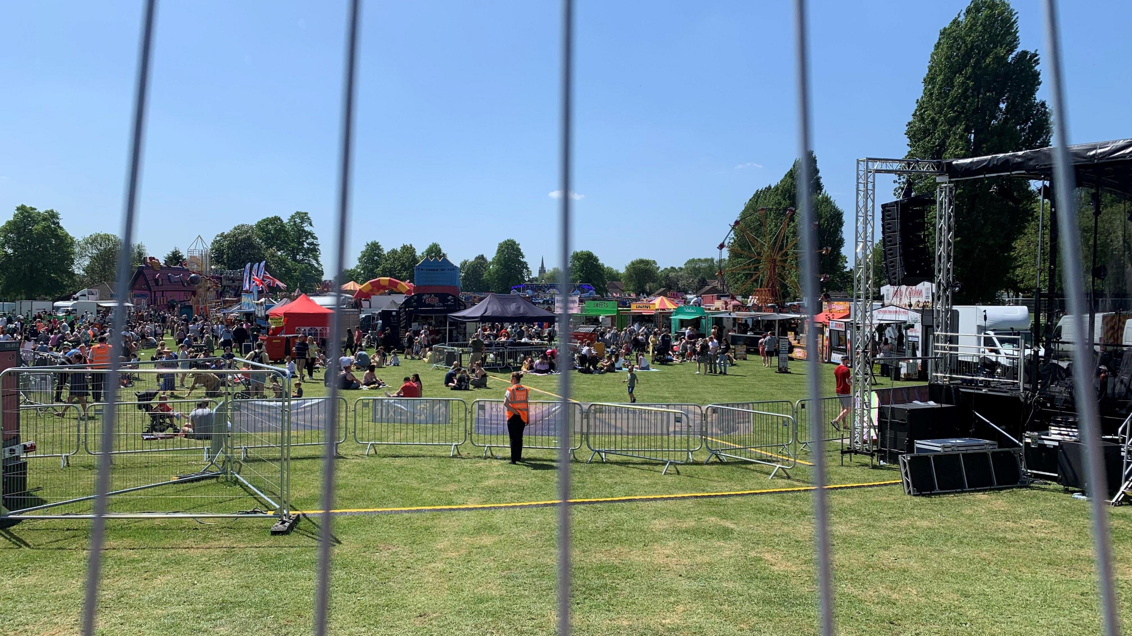 Festival at the village green with a stage in the background 