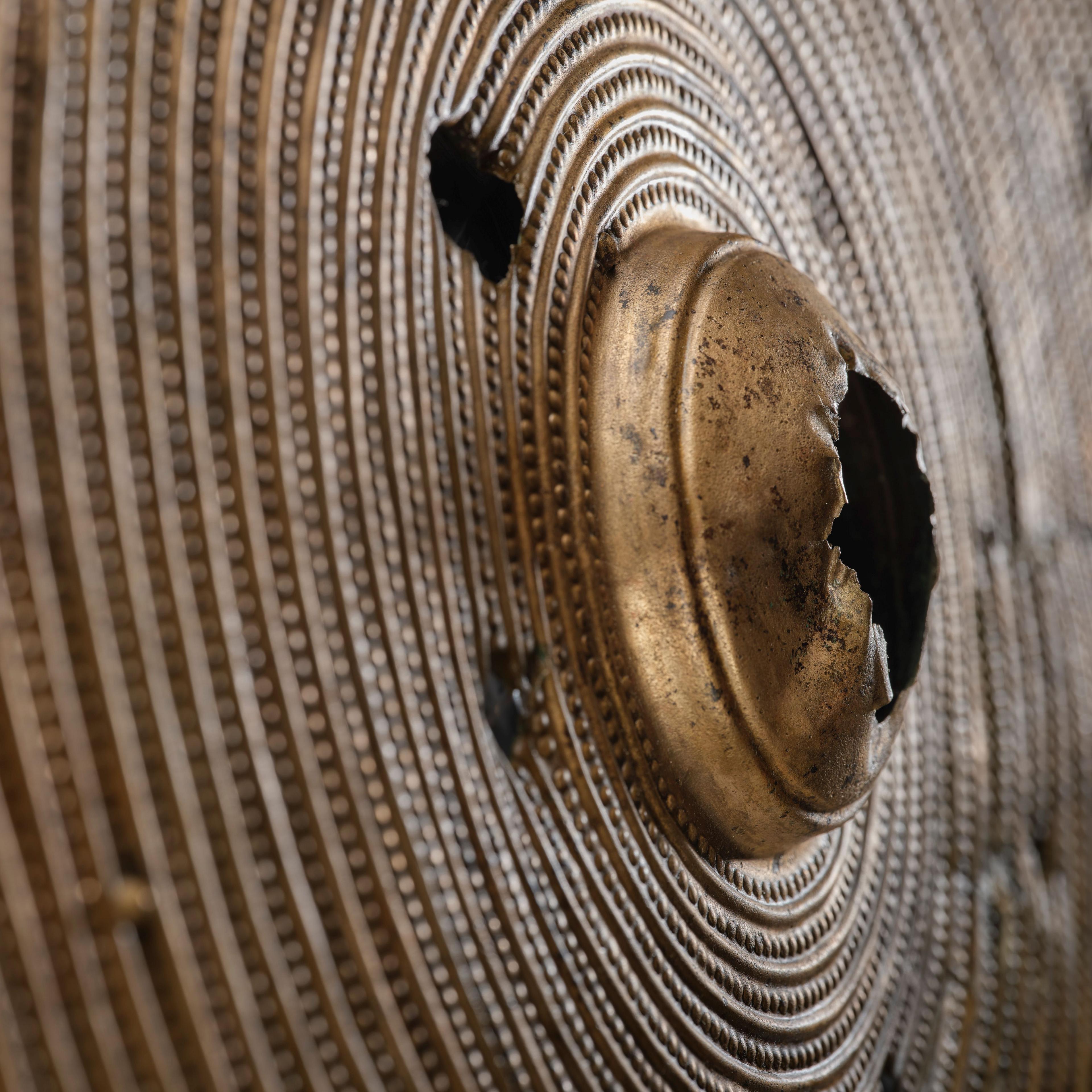 A close up of the shield showing damage it has taken.