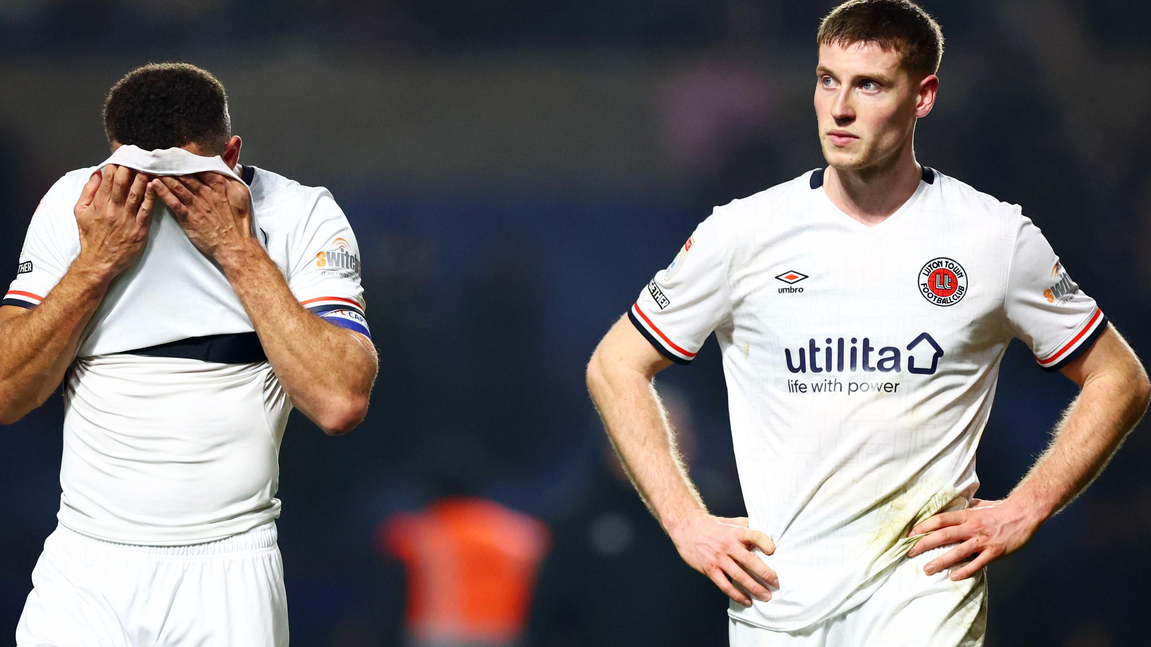 Carlton Morris and Mark McGuinness leave the pitch following Luton Town's defeat at Oxford United