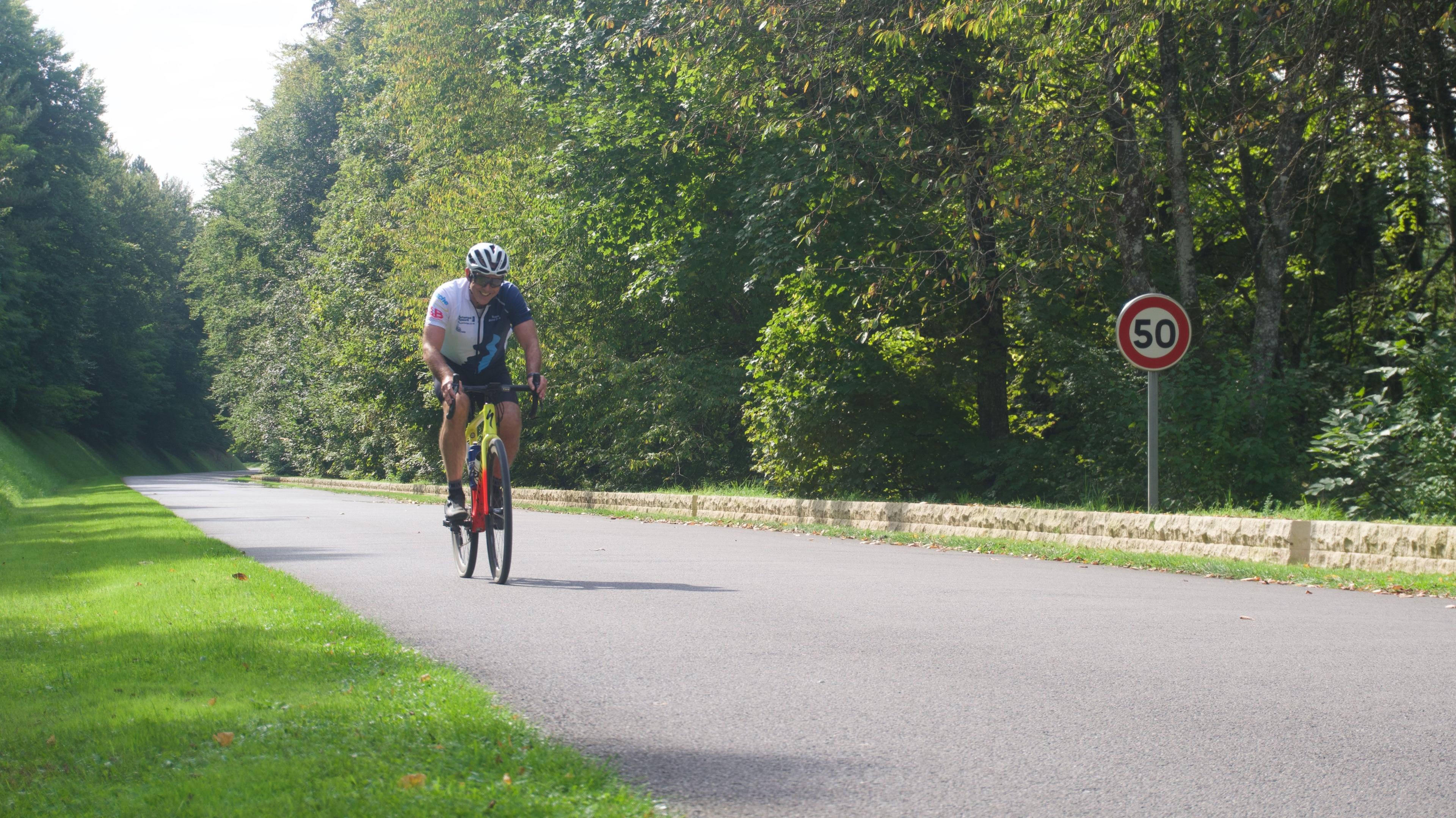 A man riding a bicycle on a road in France