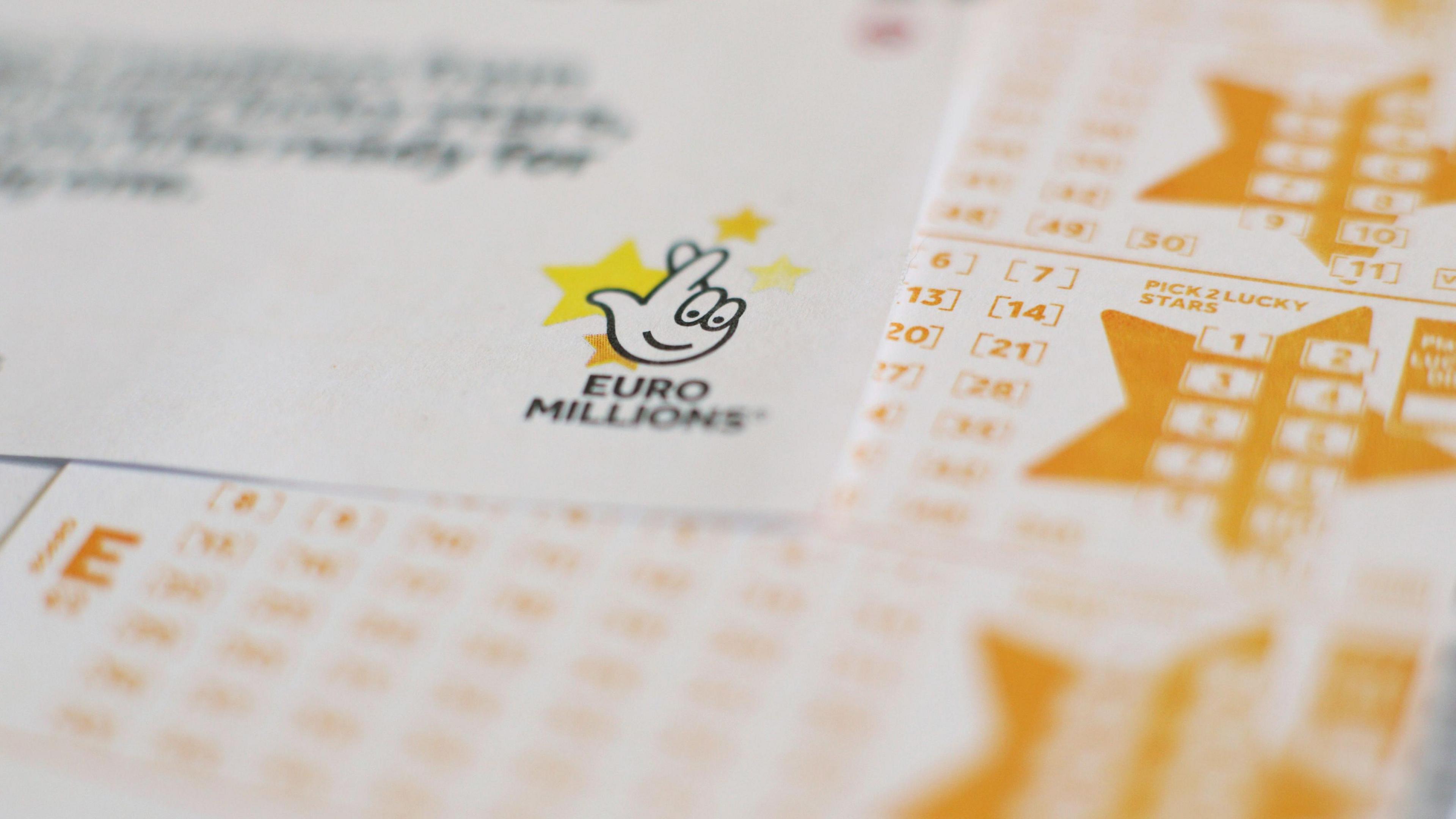 White and yellow Euromillions lottery slips seen stacked up