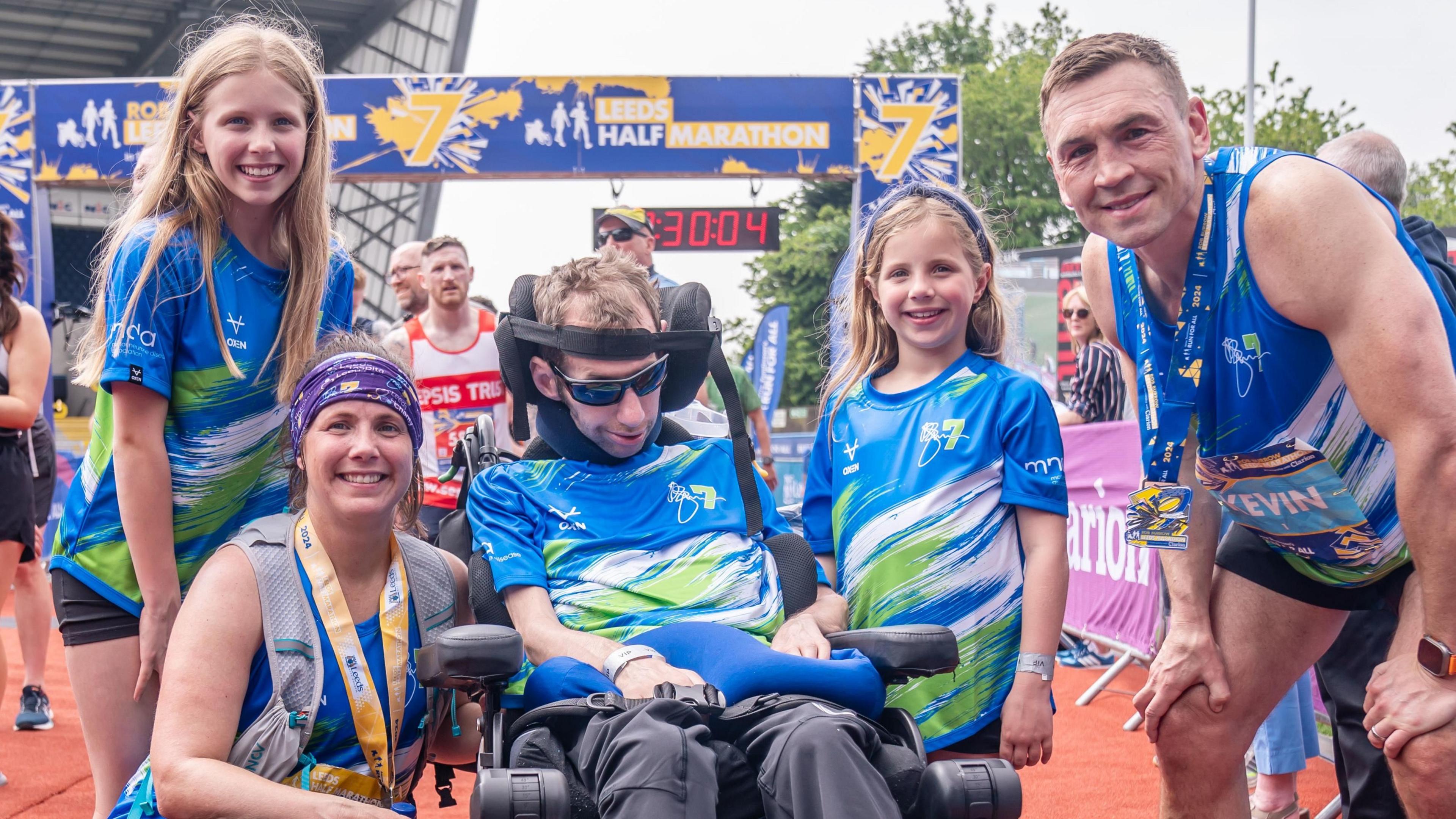 Rob Burrow pictured with his wife, children and Kevin Sinfield