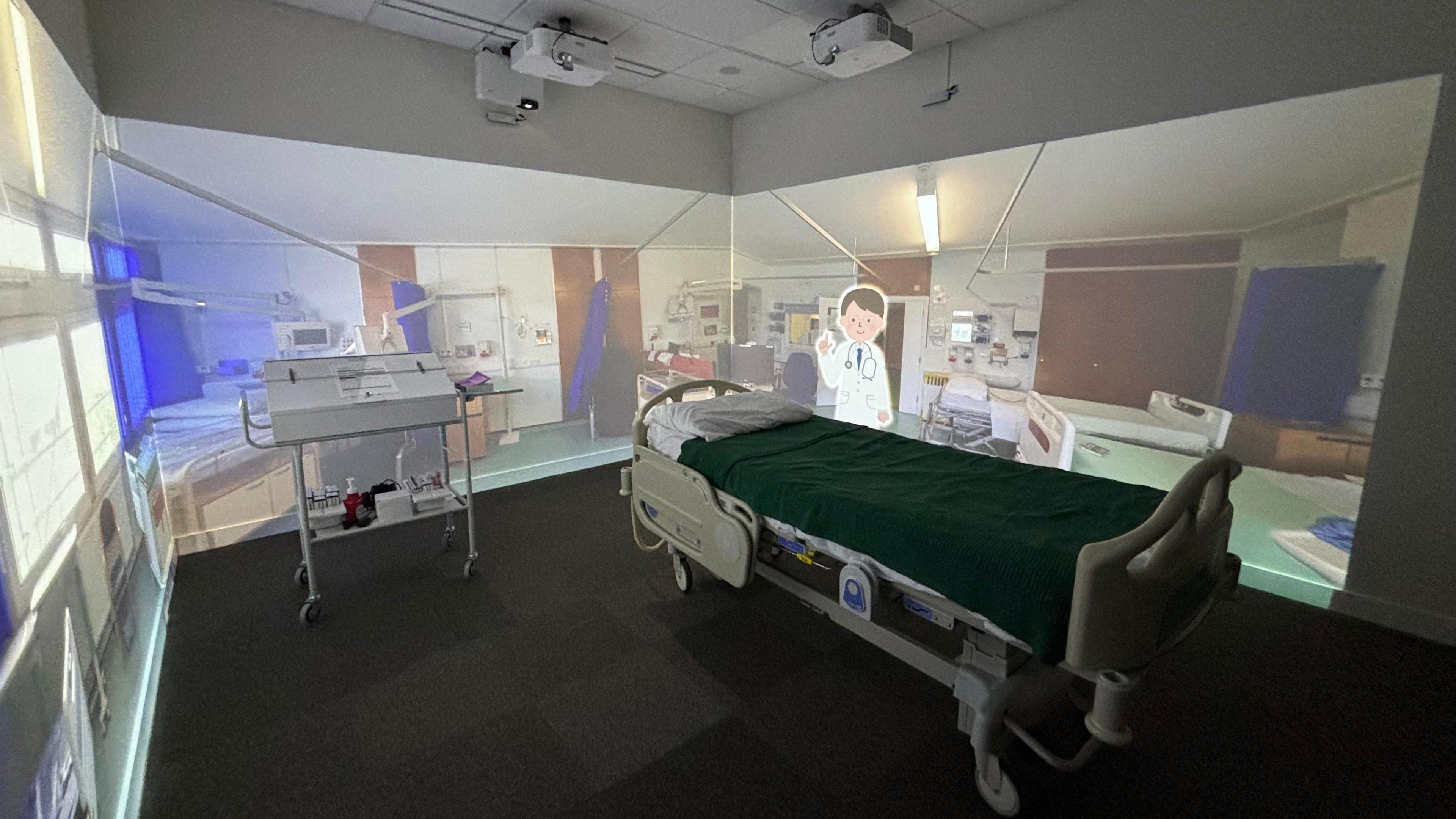 A mocked-up hospital room, including a bed and equipment, inside the new training facility