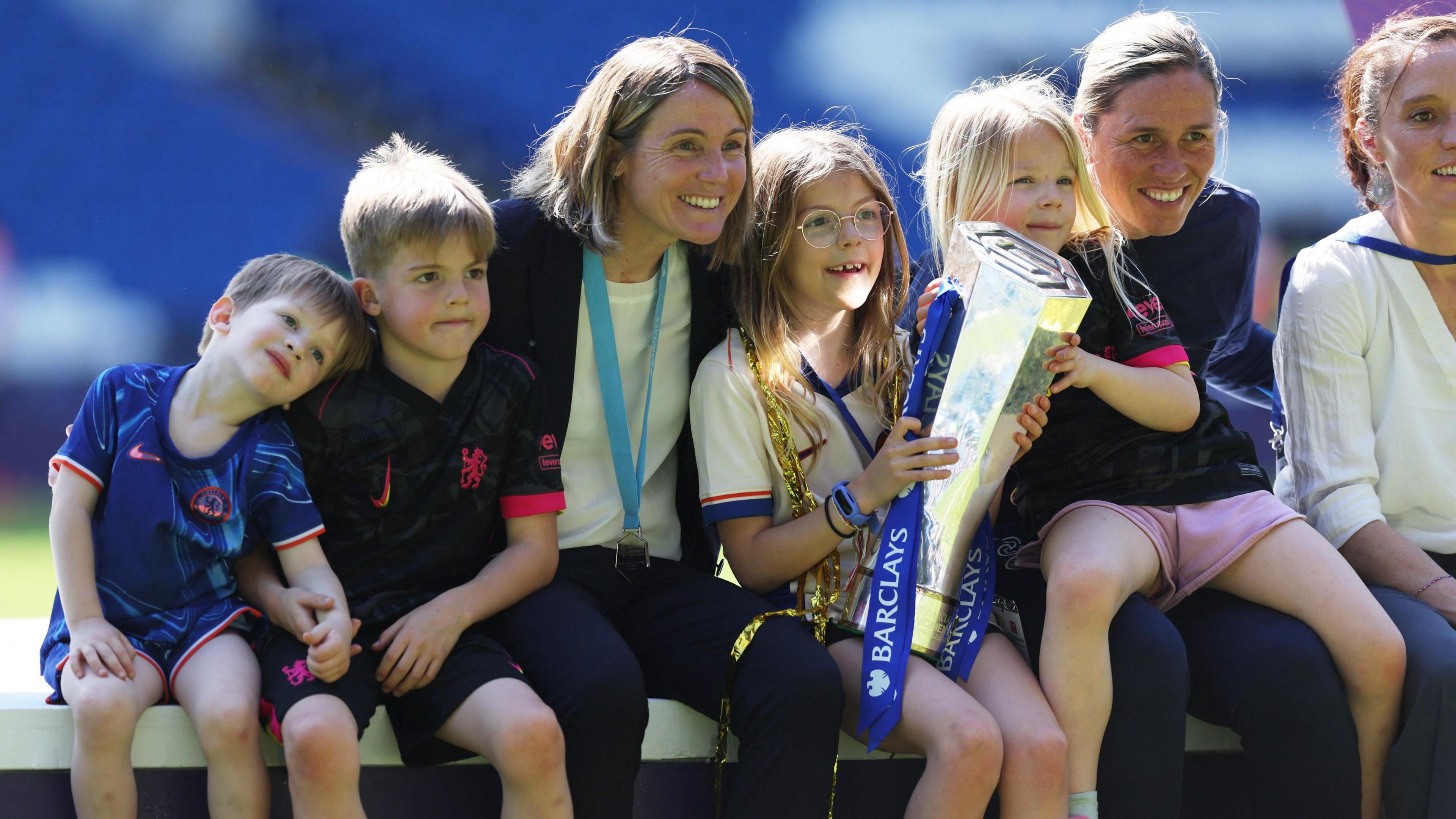 Sonia Bompastor and assistant Camille Abily celebrate with their children 