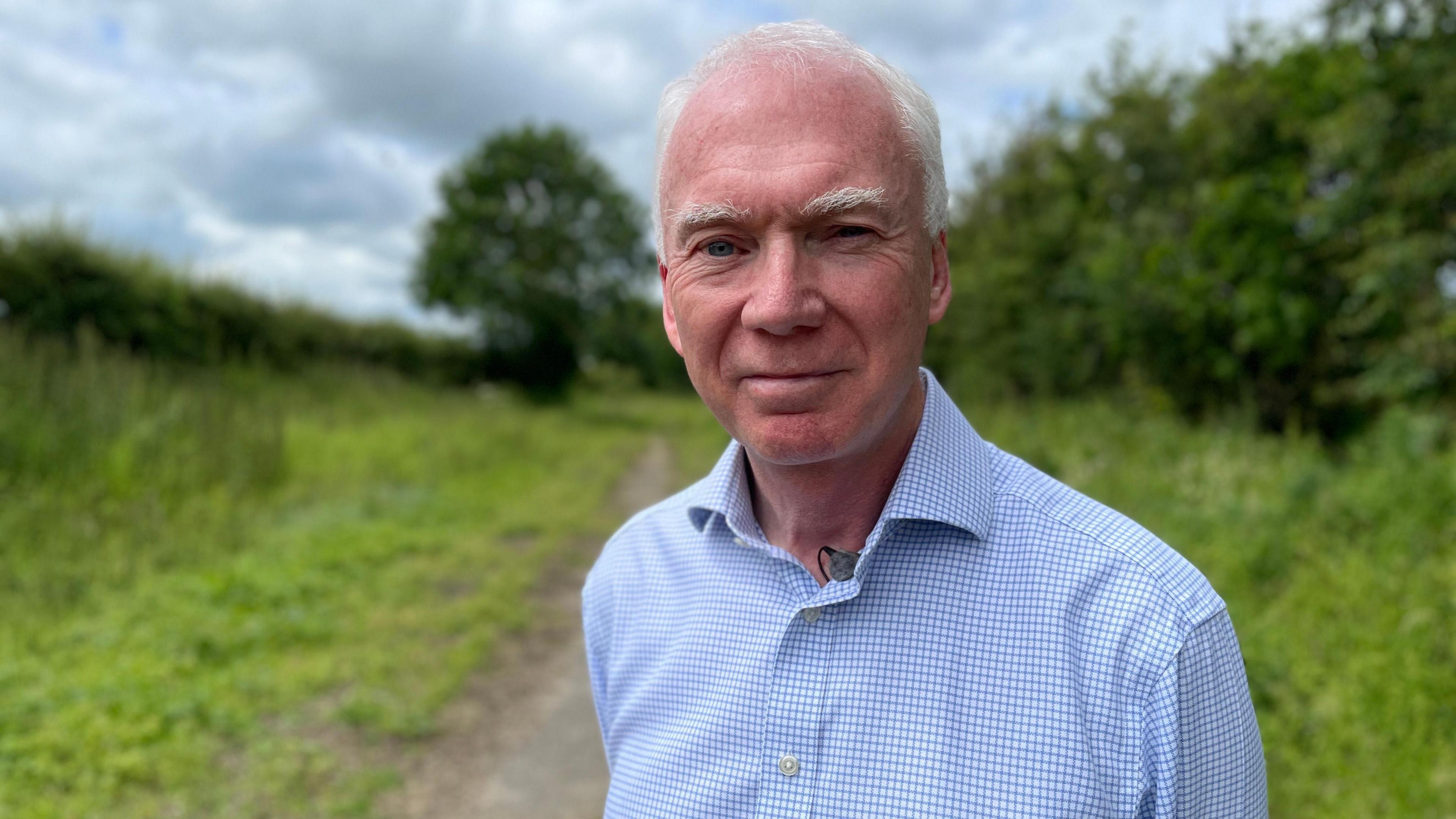 Stephen Mallinson standing in the countryside by the old Varsity railway line