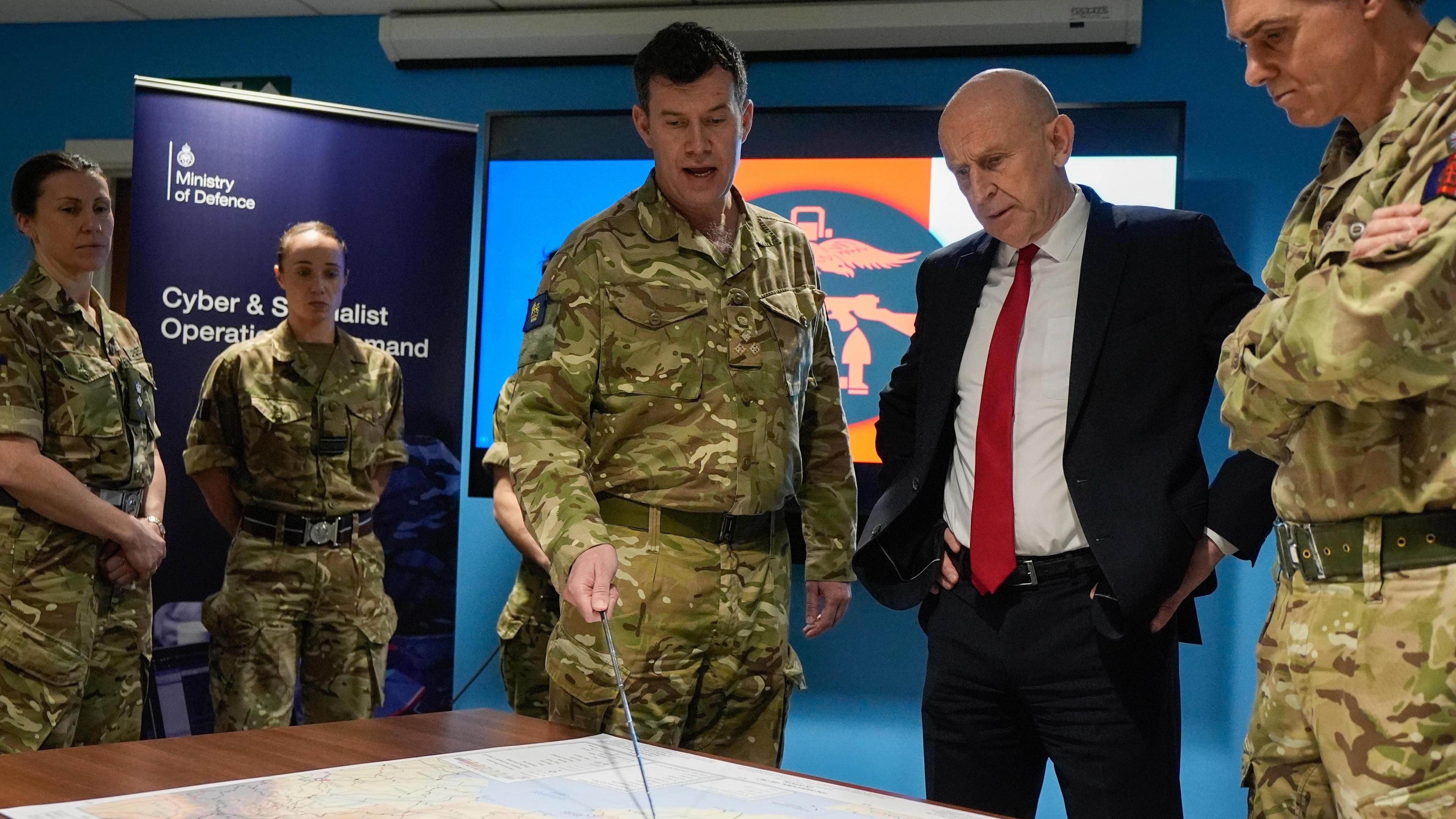 Defence Secretary John Healey is given a briefing as he meets military personnel during a visit to the Permanent Joint Headquarters in Northwood, London,