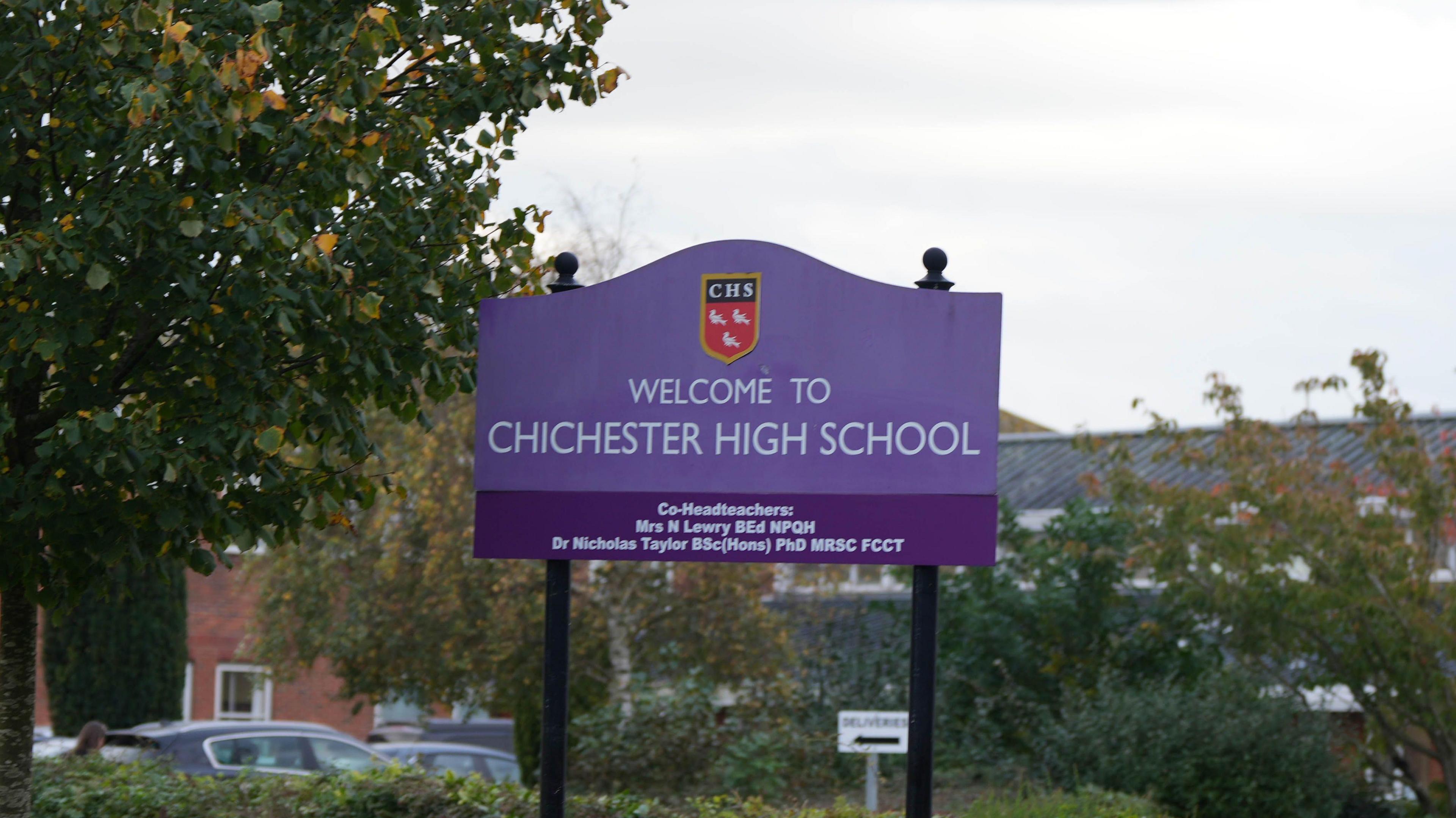 A purple sign reads 'welcome to Chichester High School' 