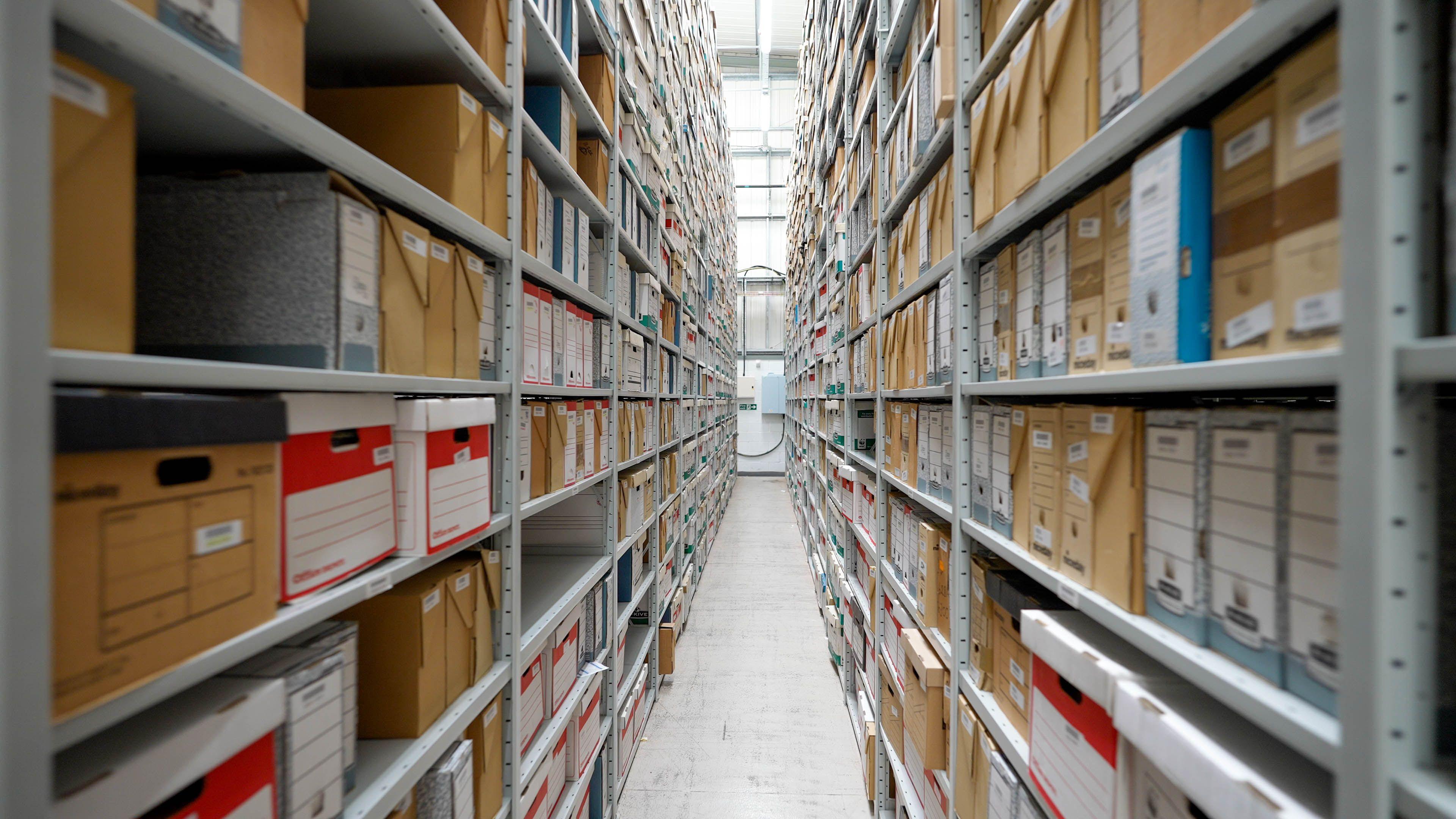Rows of boxes are stored on shelving at the National Forensics Archive 