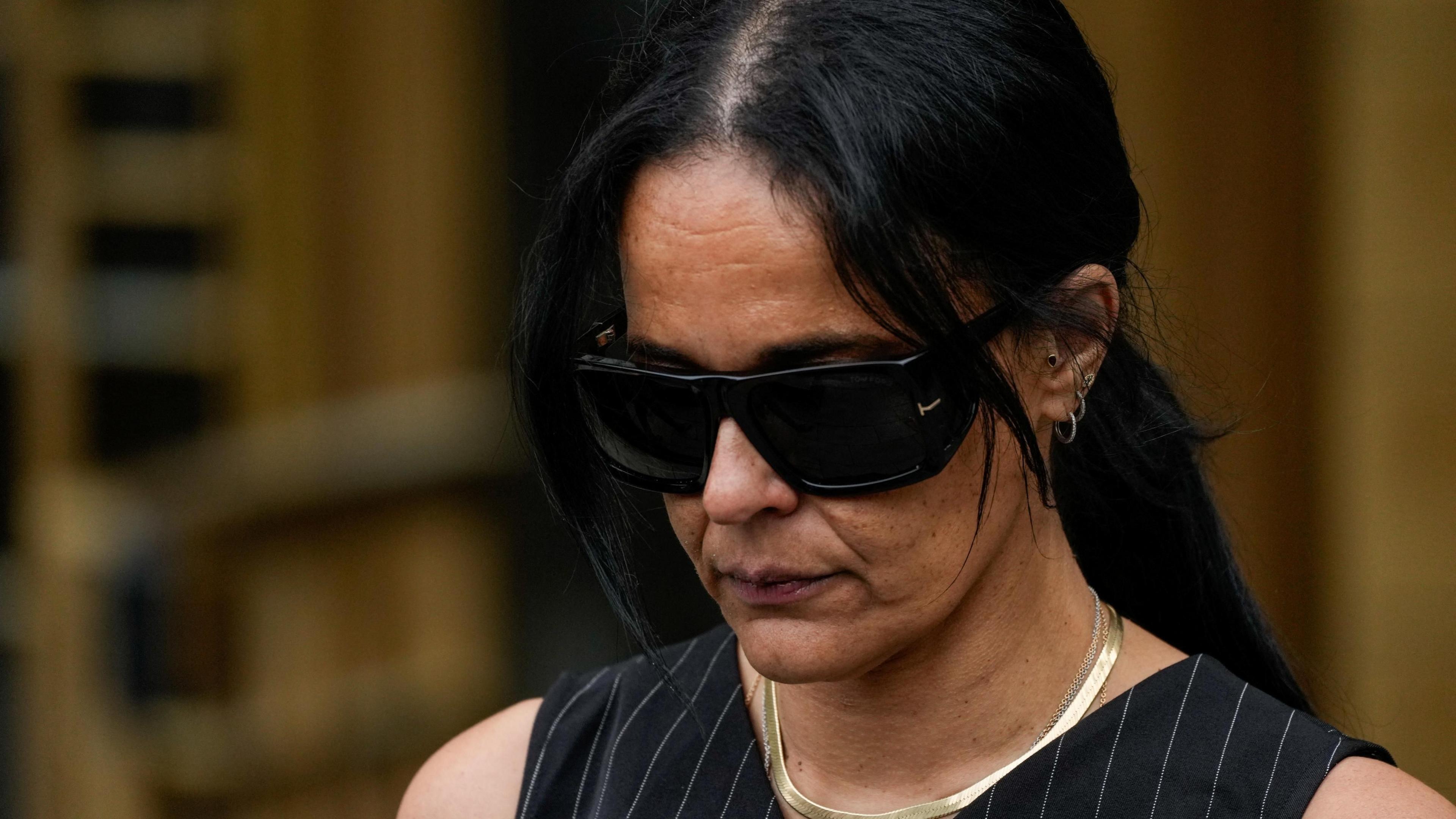 Capricorn Clark walking out of talk wearing dark sunglasses