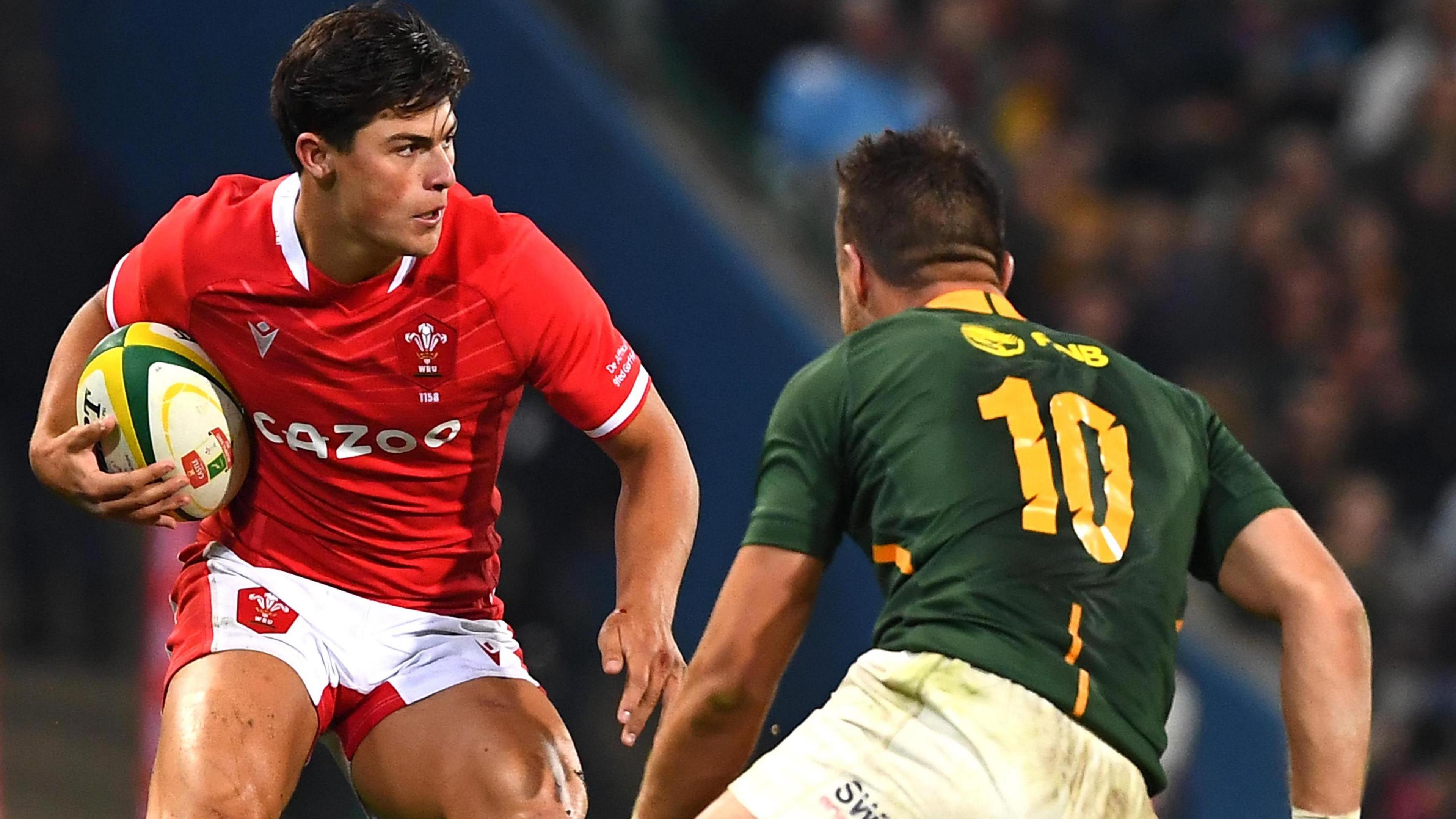 Wales wing Louis Rees-Zammit, who scored a try in Wales' narrow defeat against South Africa in Pretoria in the summer of 2022, with the ball in his hands, up against South Africa's Handre Pollard