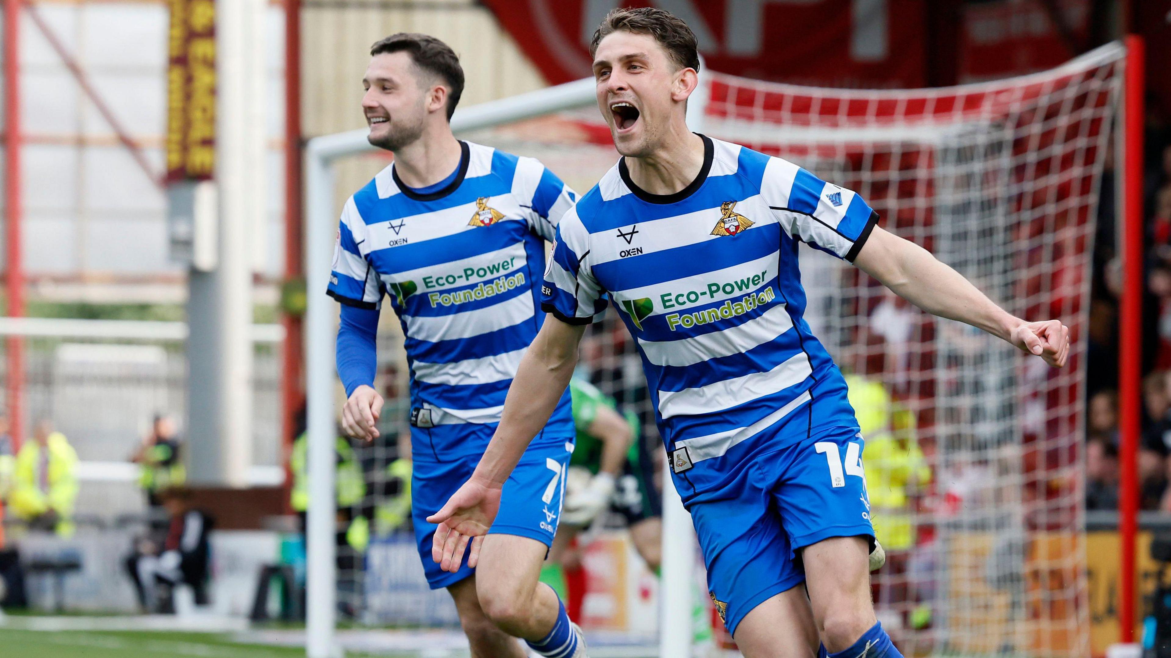 Harrison Biggins celebrates scoring Doncaster's second goal at Crewe