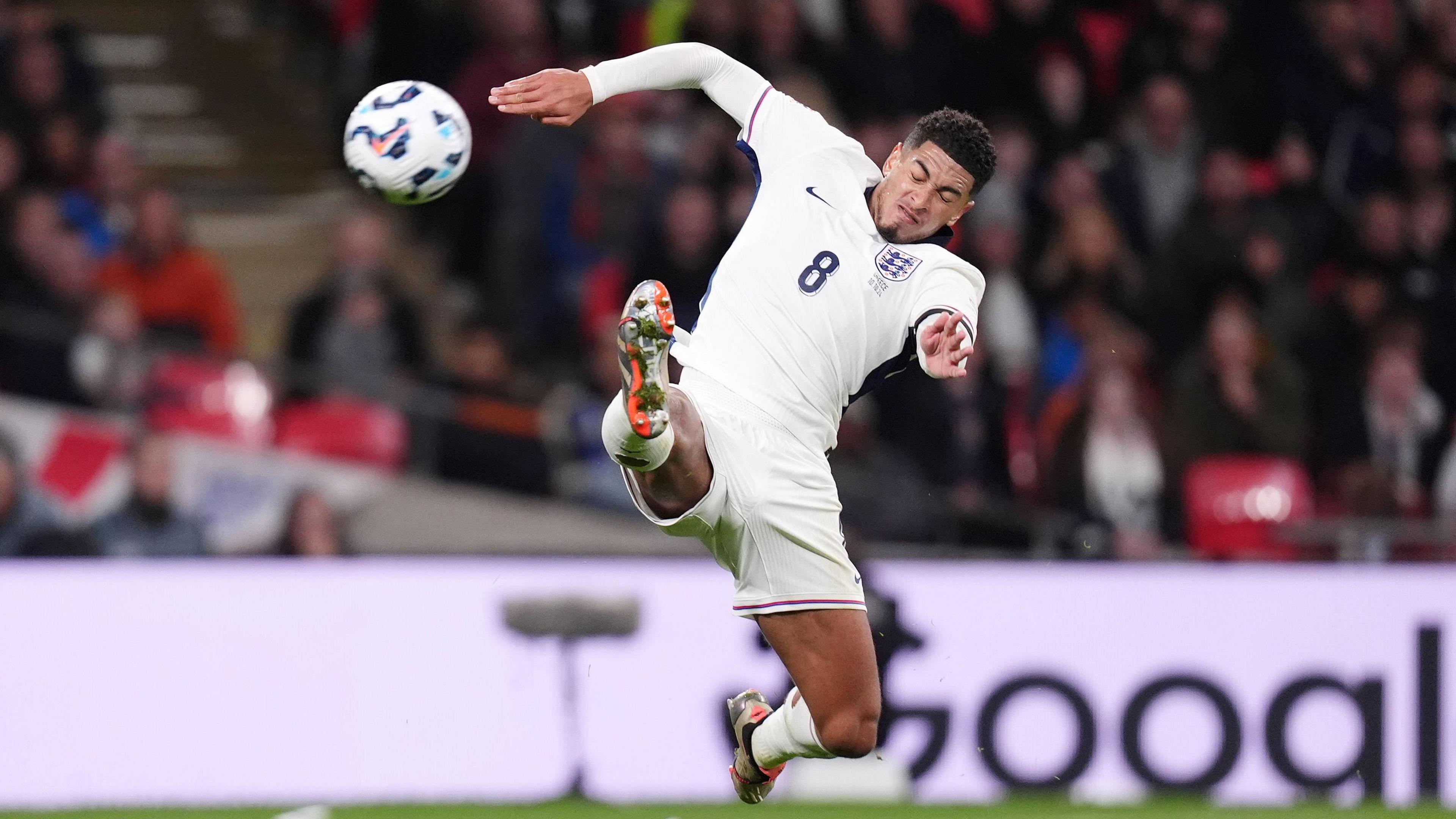 Jude Bellingham kicking the ball wearing an England kit