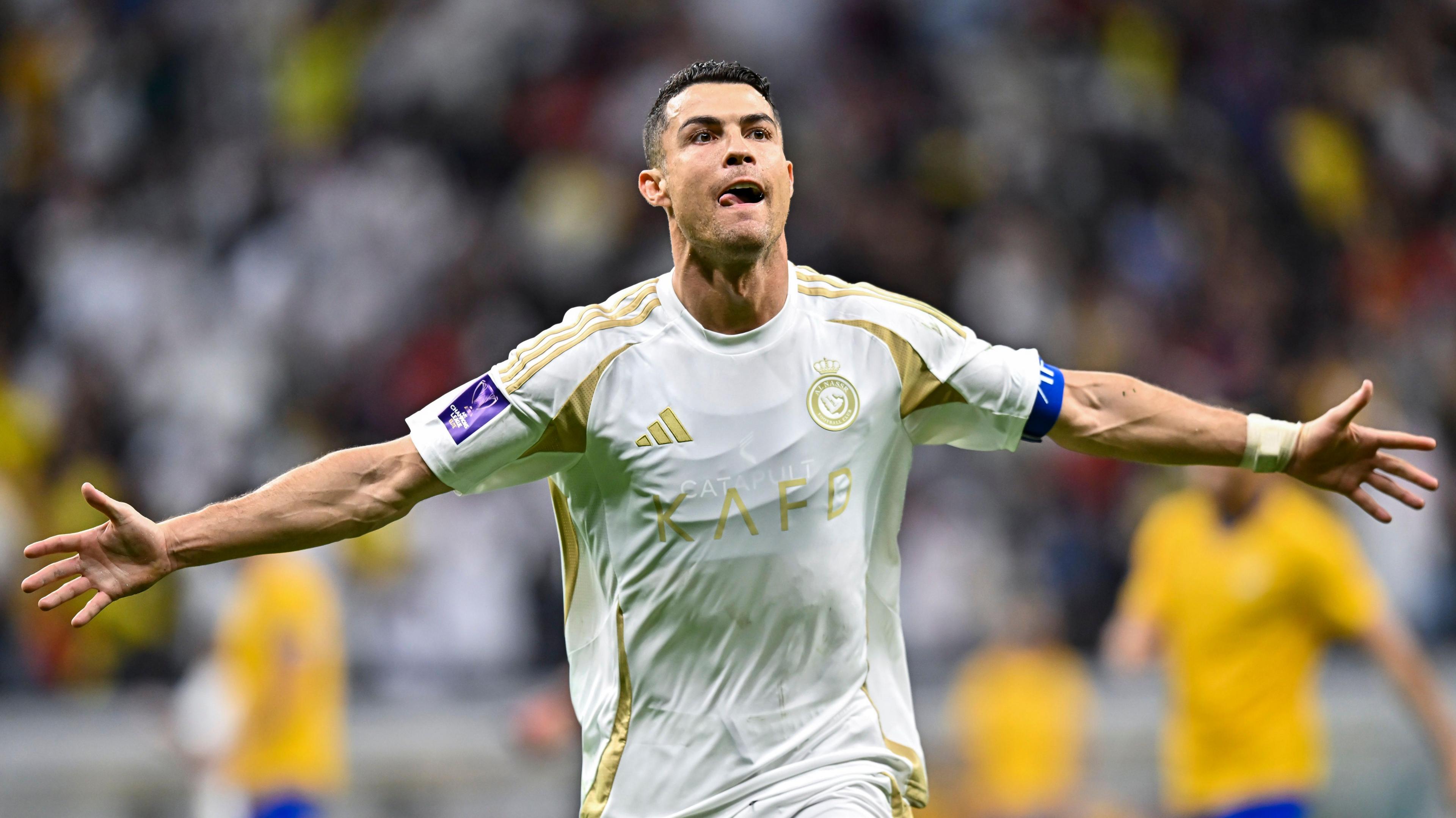 Cristiano Ronaldo celebrates a goal holding his arms out while he runs