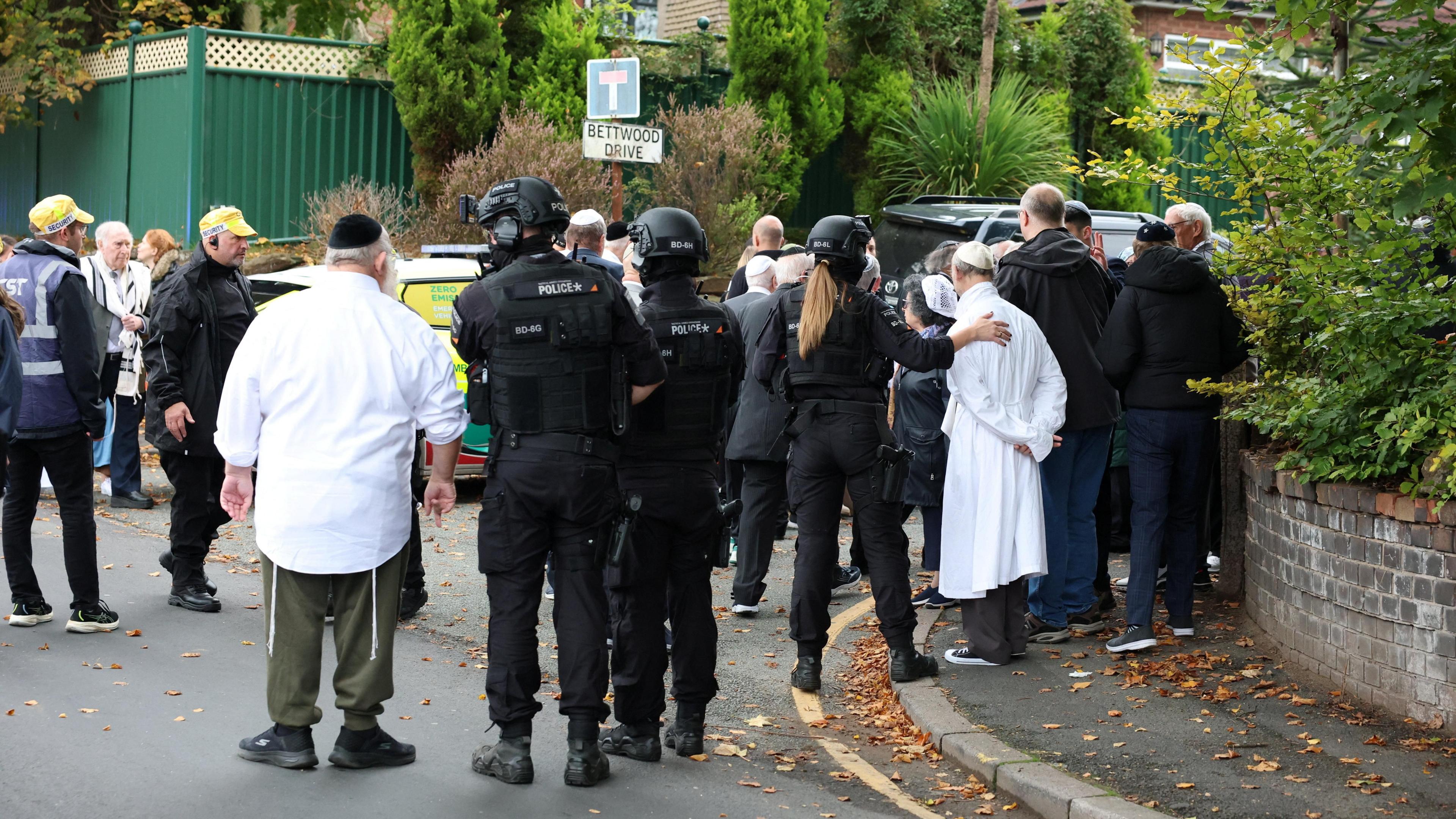 Police and community members gathered near the scene
