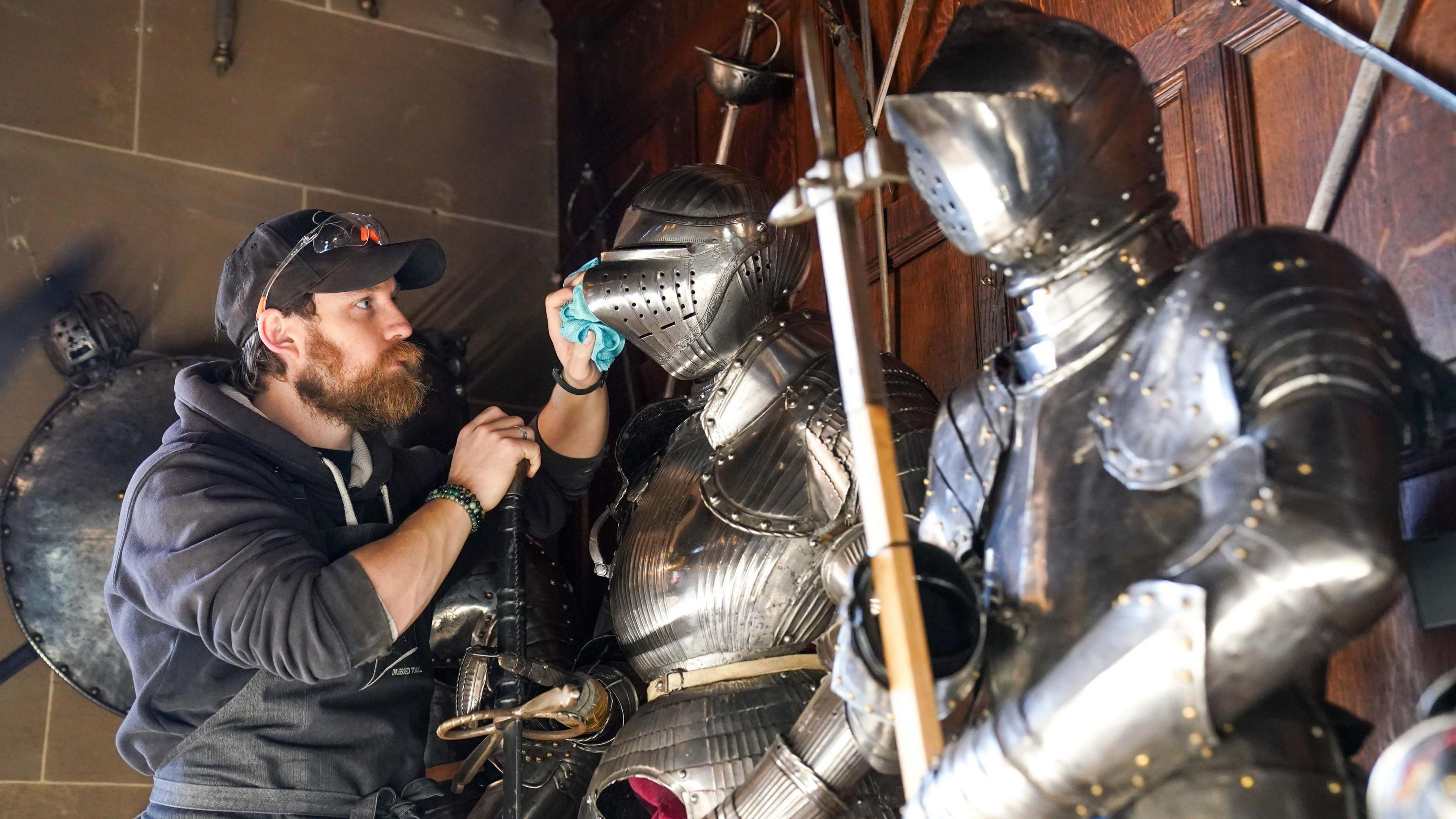 Man cleaning armour