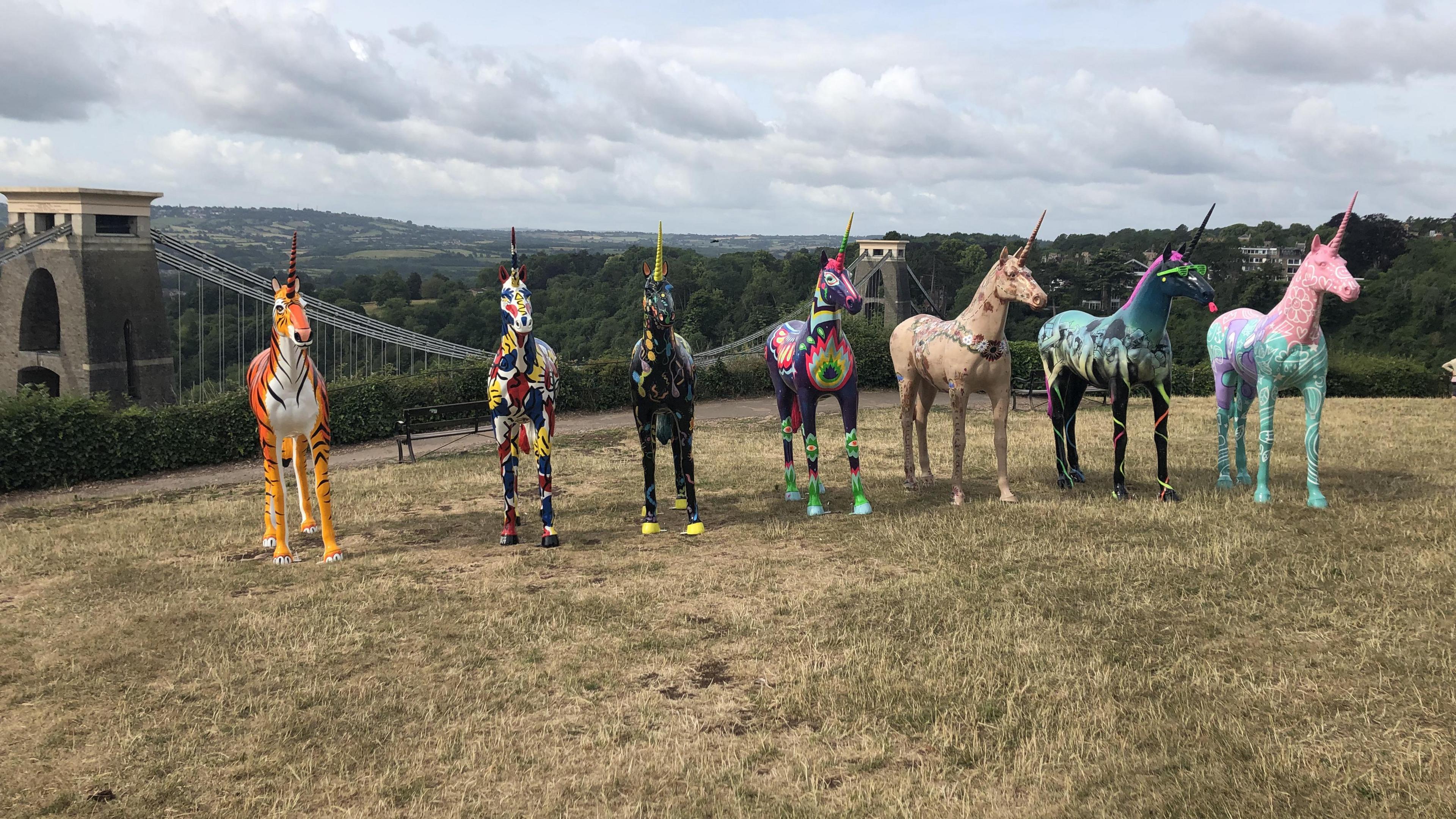 Unicorn statues with the Clifton Suspension Bridge in the background