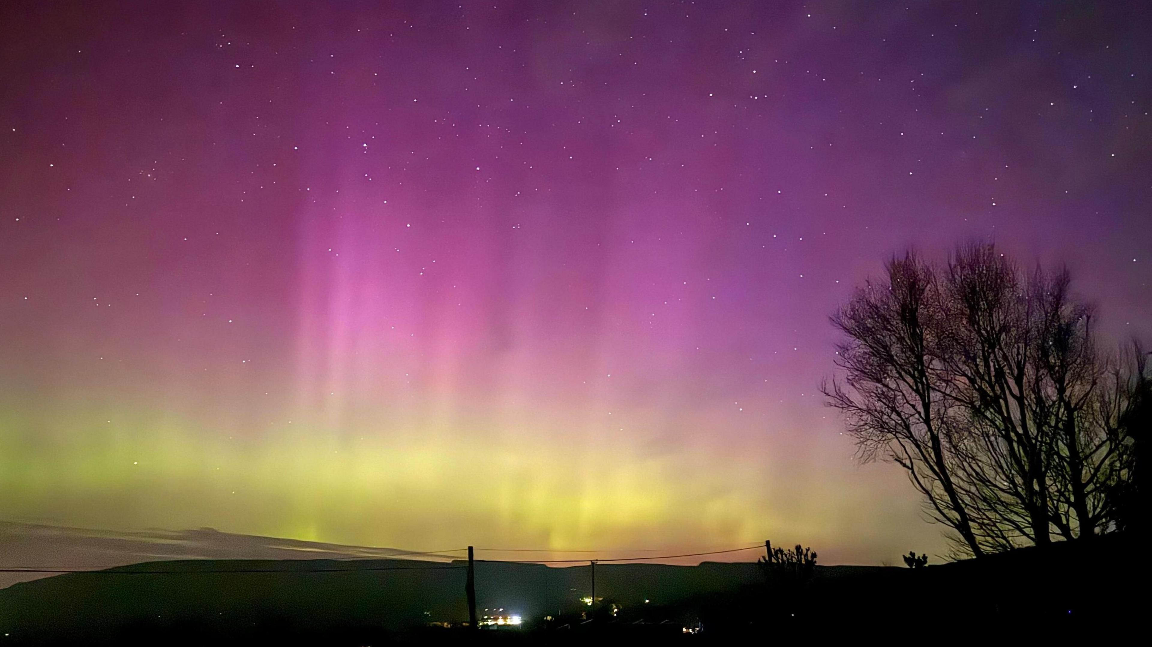 bright colours of purple and green fill the picture showing the Northern Lights