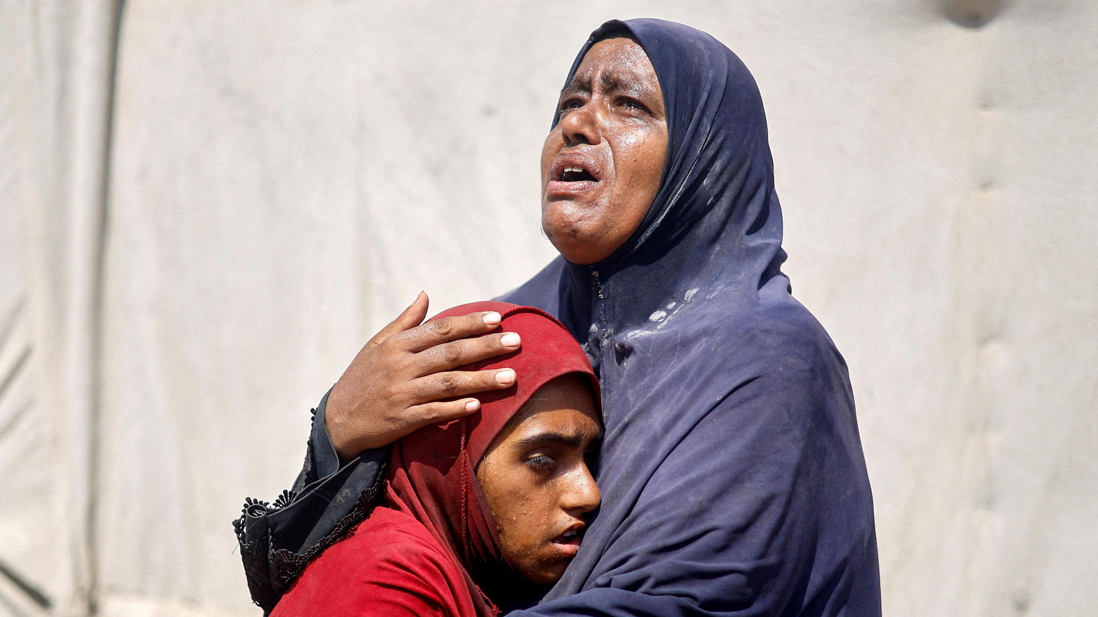 Palestinians, who fled the eastern part of Khan Younis after they were ordered by Israeli army to evacuate their neighborhood, react upon their arrival at Nasser hospital, amid Israel-Hamas conflict, in Khan Younis in the southern Gaza Strip July 2, 2024