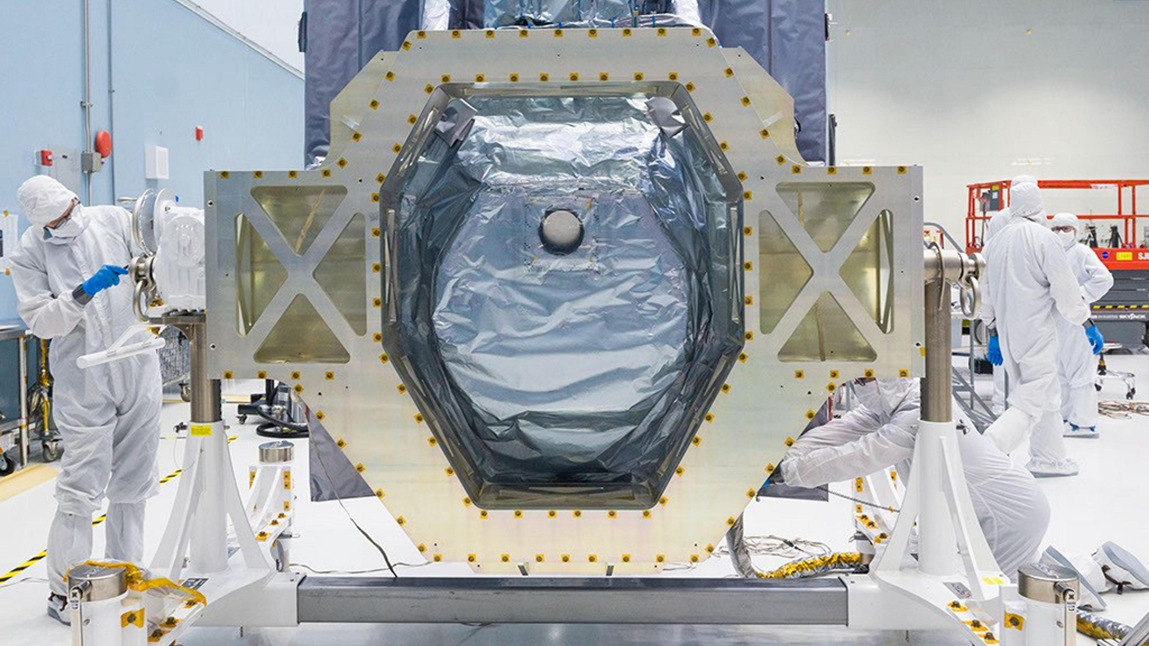 A picture of nasa engineers building the Wide Field Instrument on the telescope.