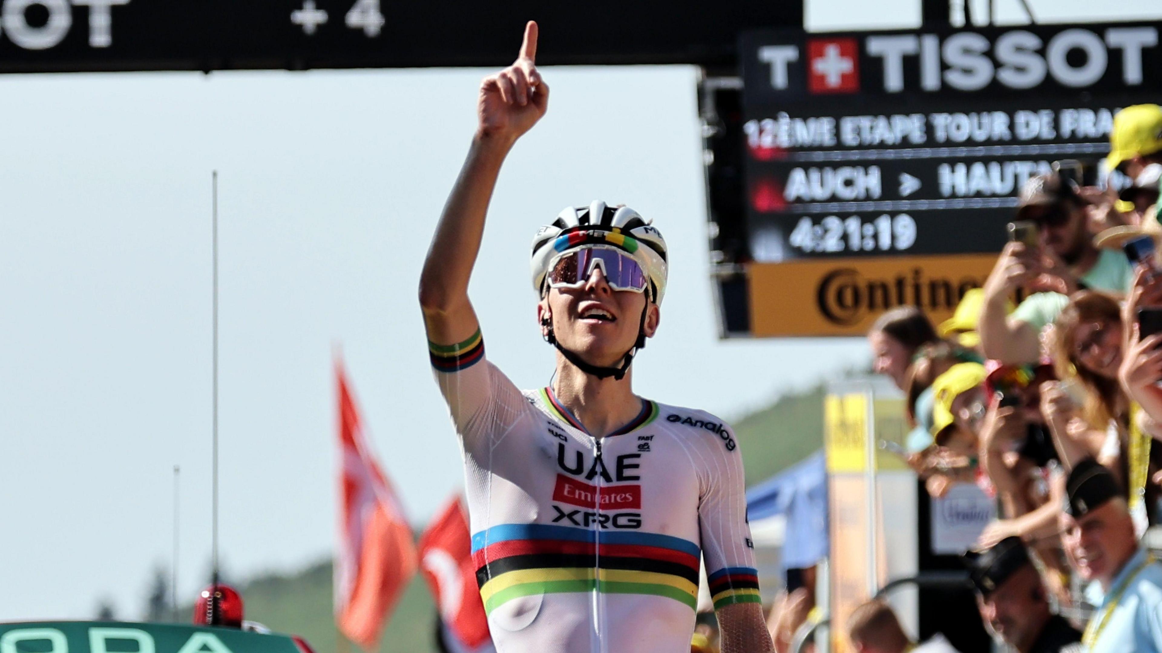 Tadej Pogacar points to the sky after winning stage 12 of the 2025 Tour de France