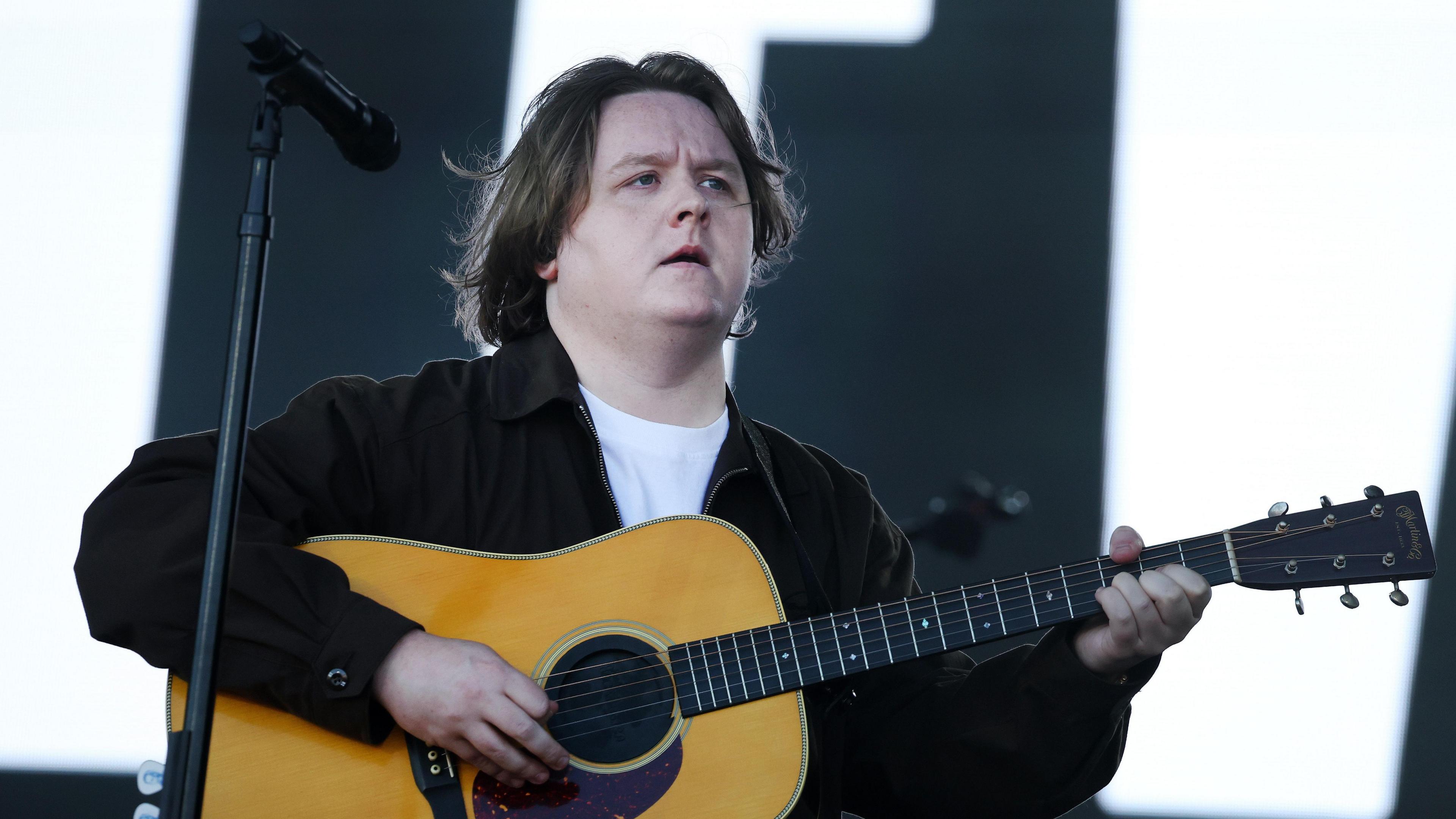 Lewis Capaldi with a guitar on stage at Glastonbury festival