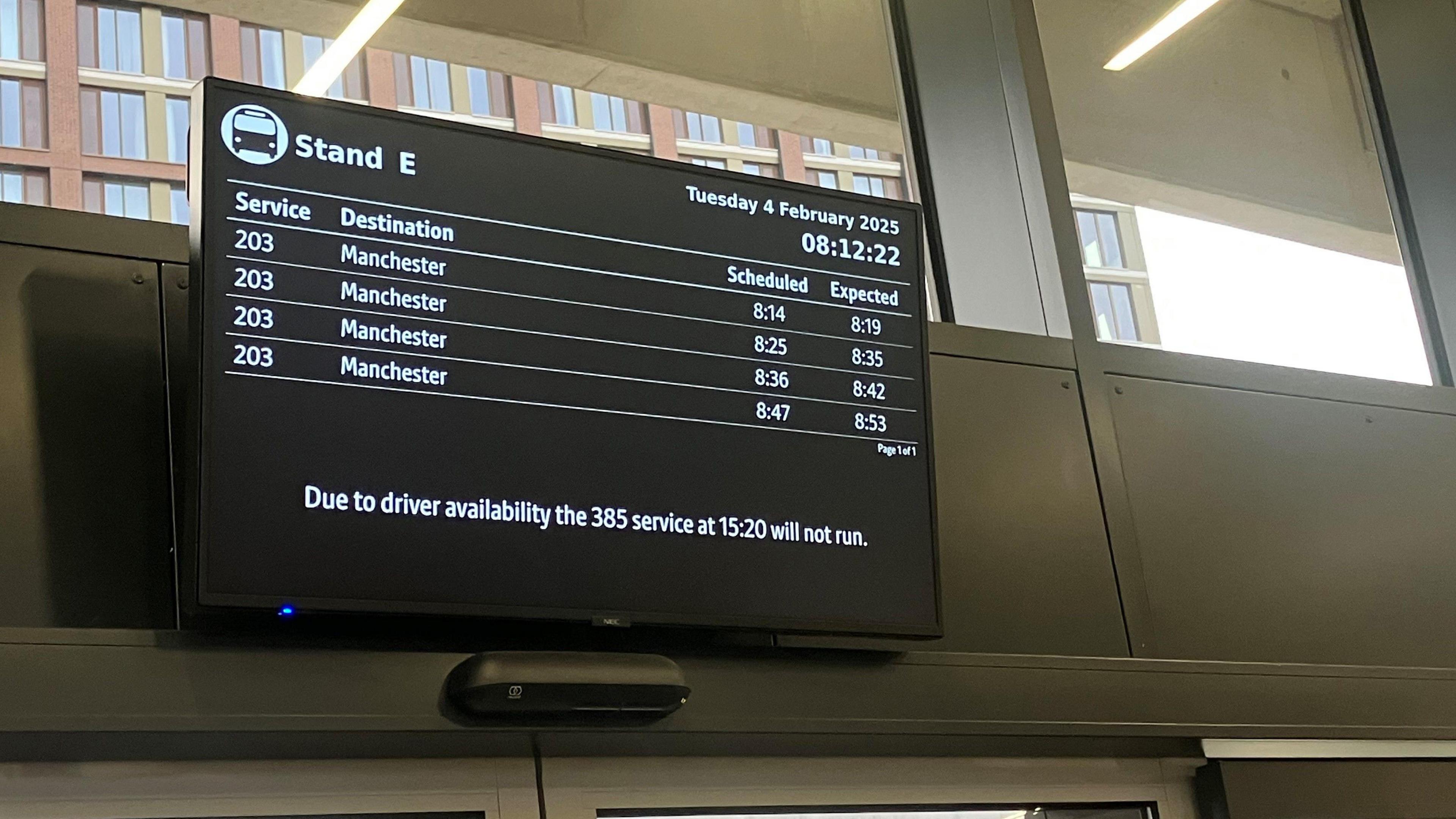 Photograph of a display board at Stockport Interchange, showing four delayed 203 bus services.