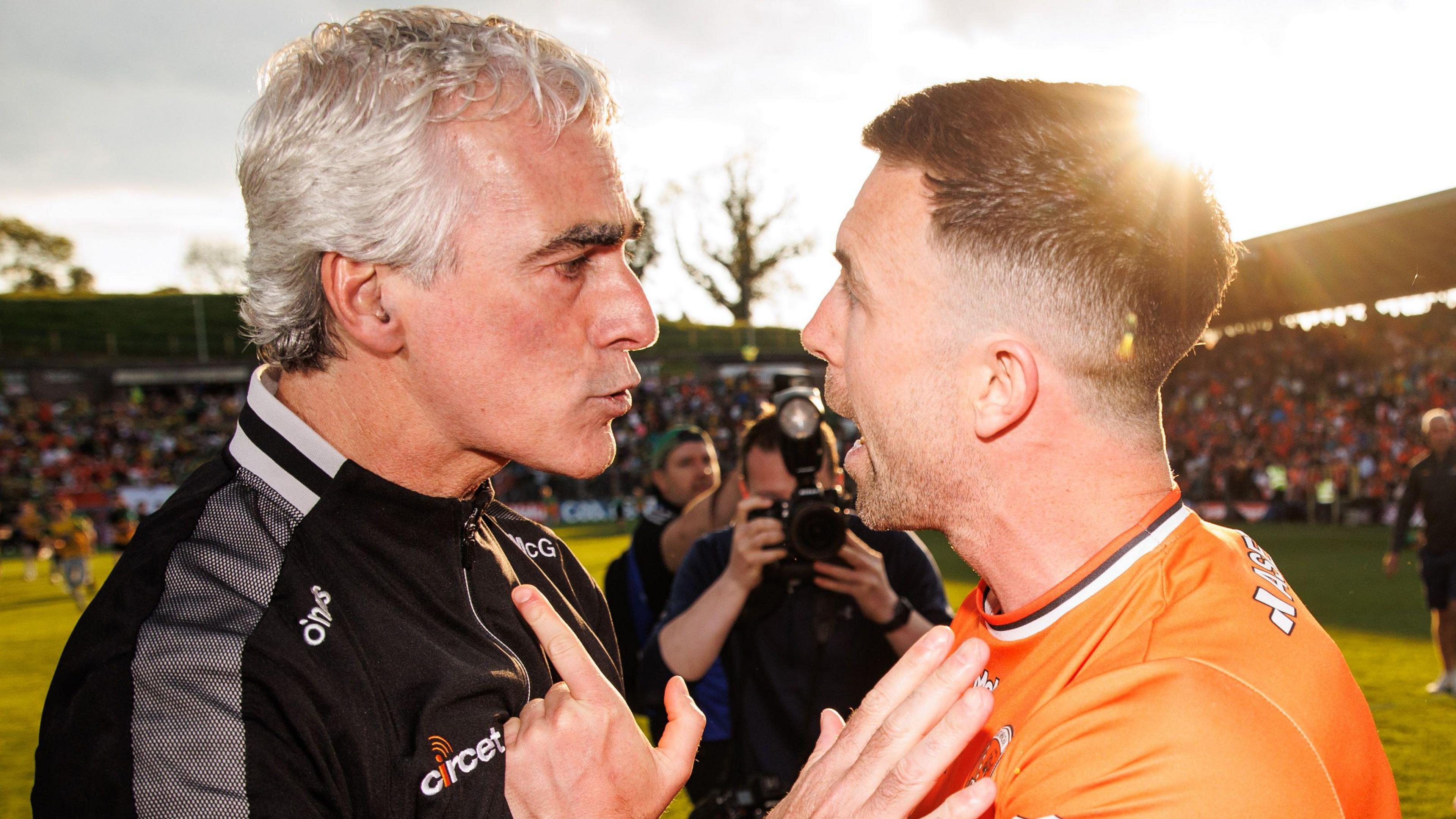 Armagh captain Aidan Forker and Donegal boss Jim McGuinness after the Clones contest