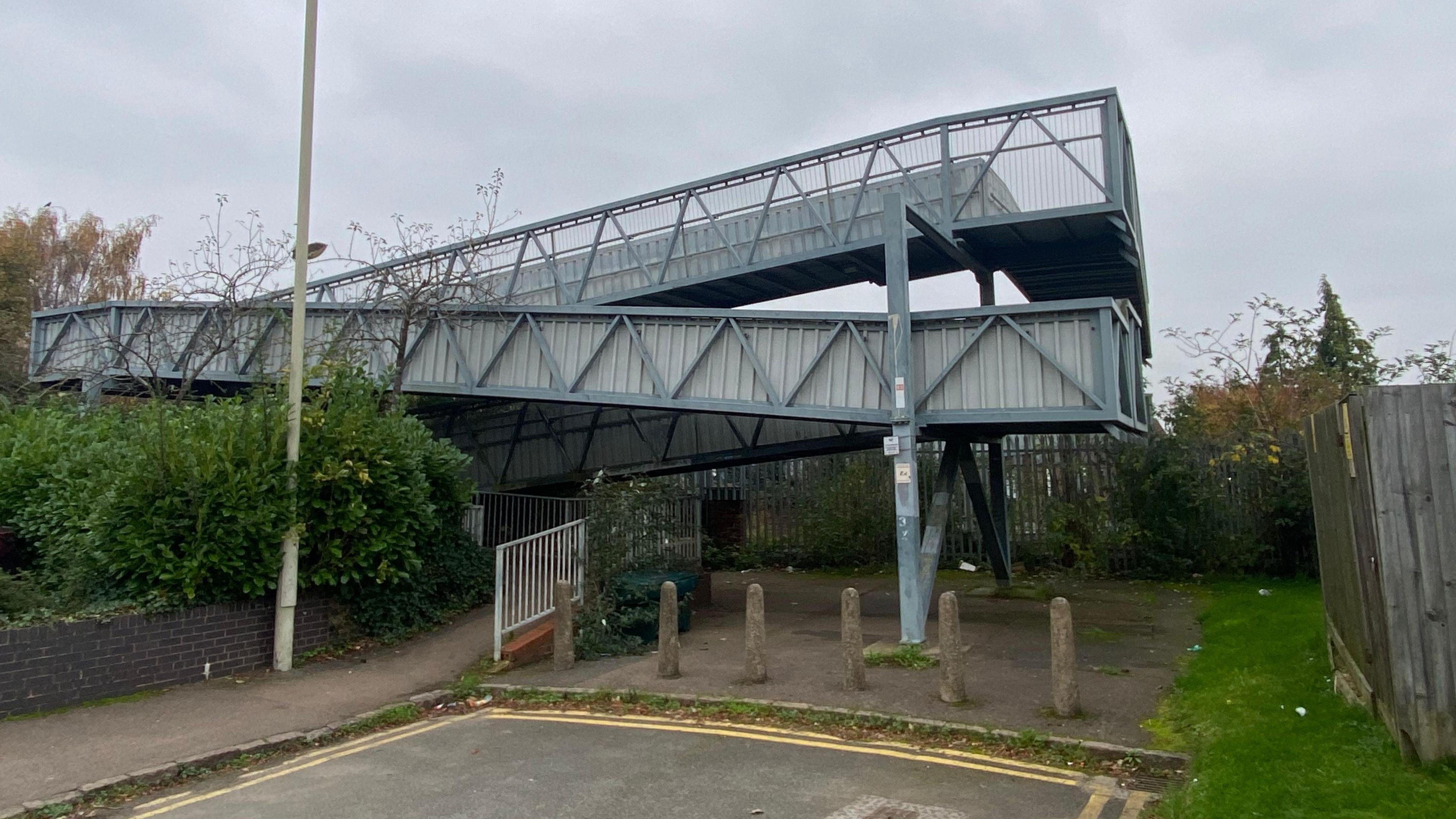 Blue and grey metallic railway bridge. 