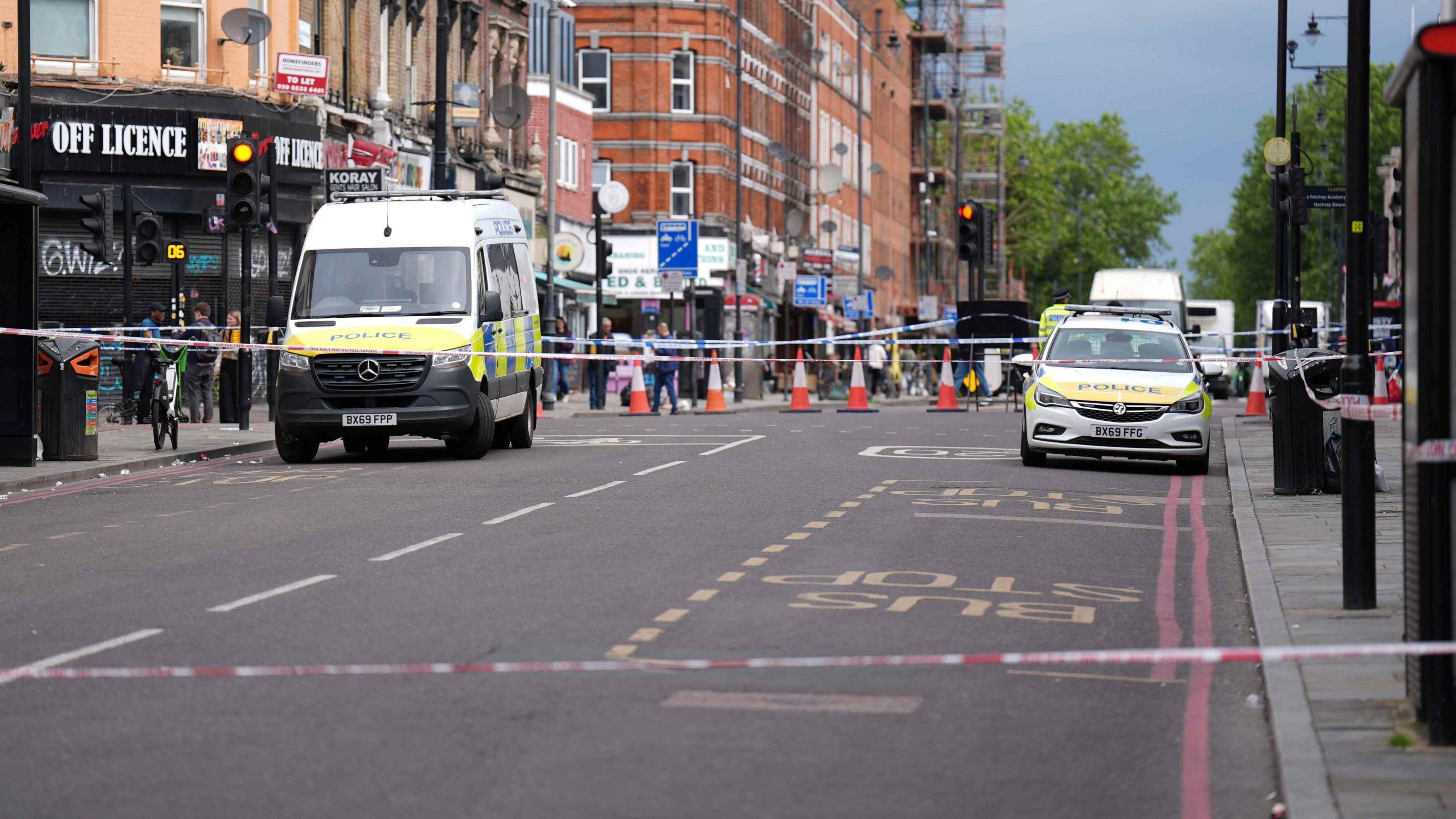 Police at the cordoned off scene of a shooting at Kingsland High Street, Hackney, east London.